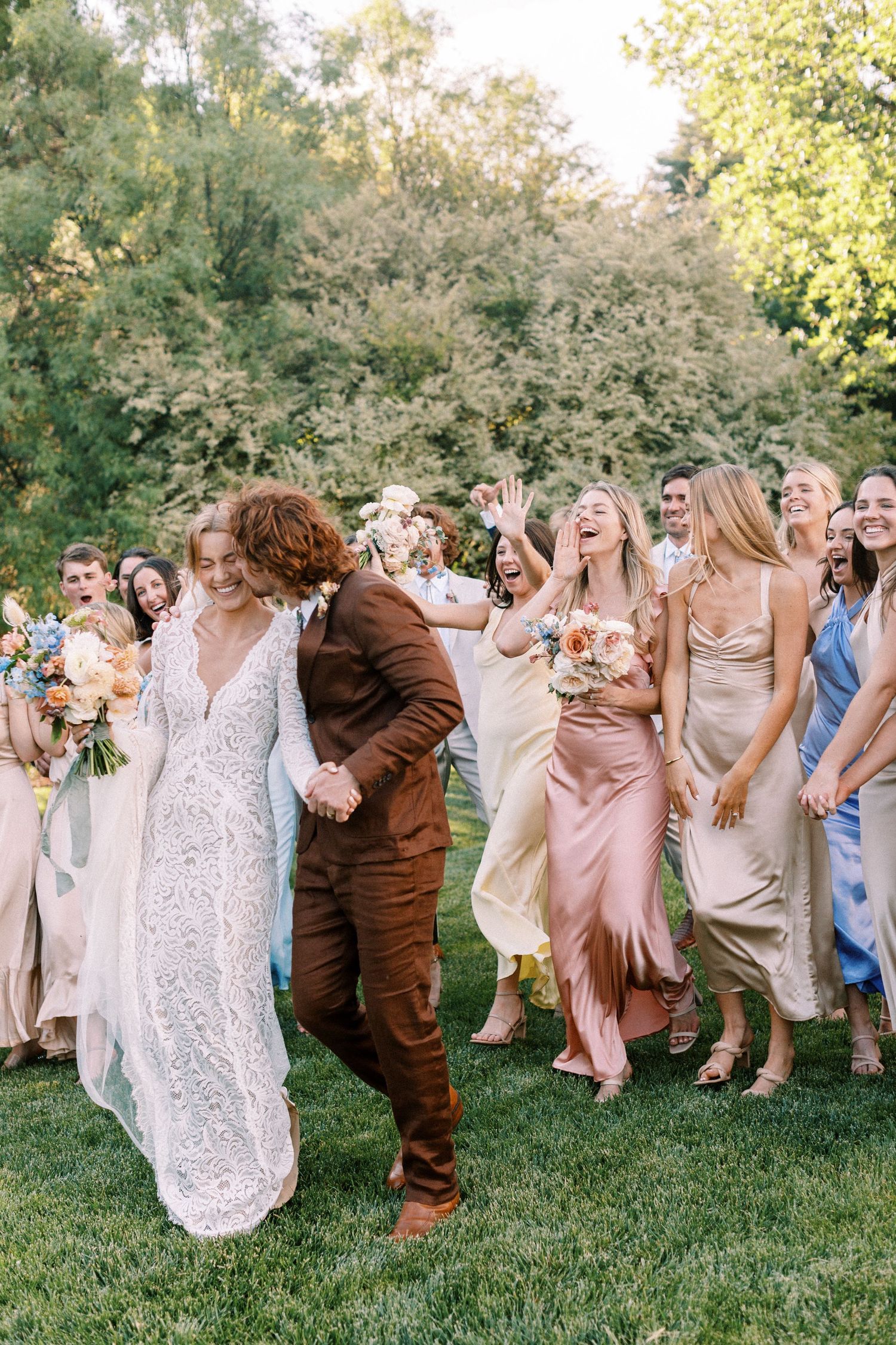 Bridesmaids cheering on couple in satin dresses at The Gage Hotel in Marathon, Texas