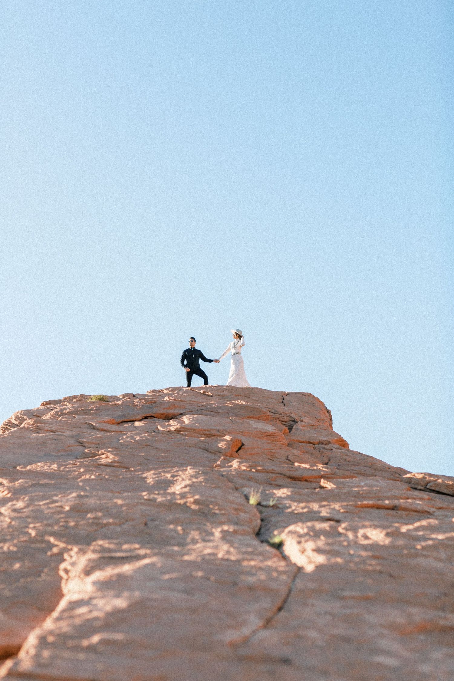 Bride and groom on top of mountain.