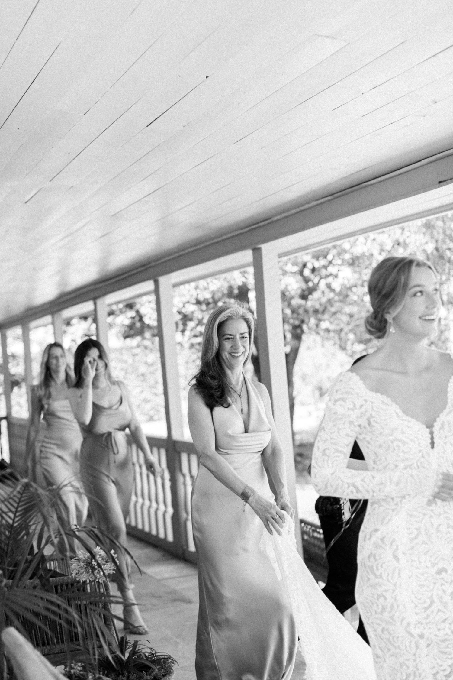 Mother of the bride and bride walking across front porch