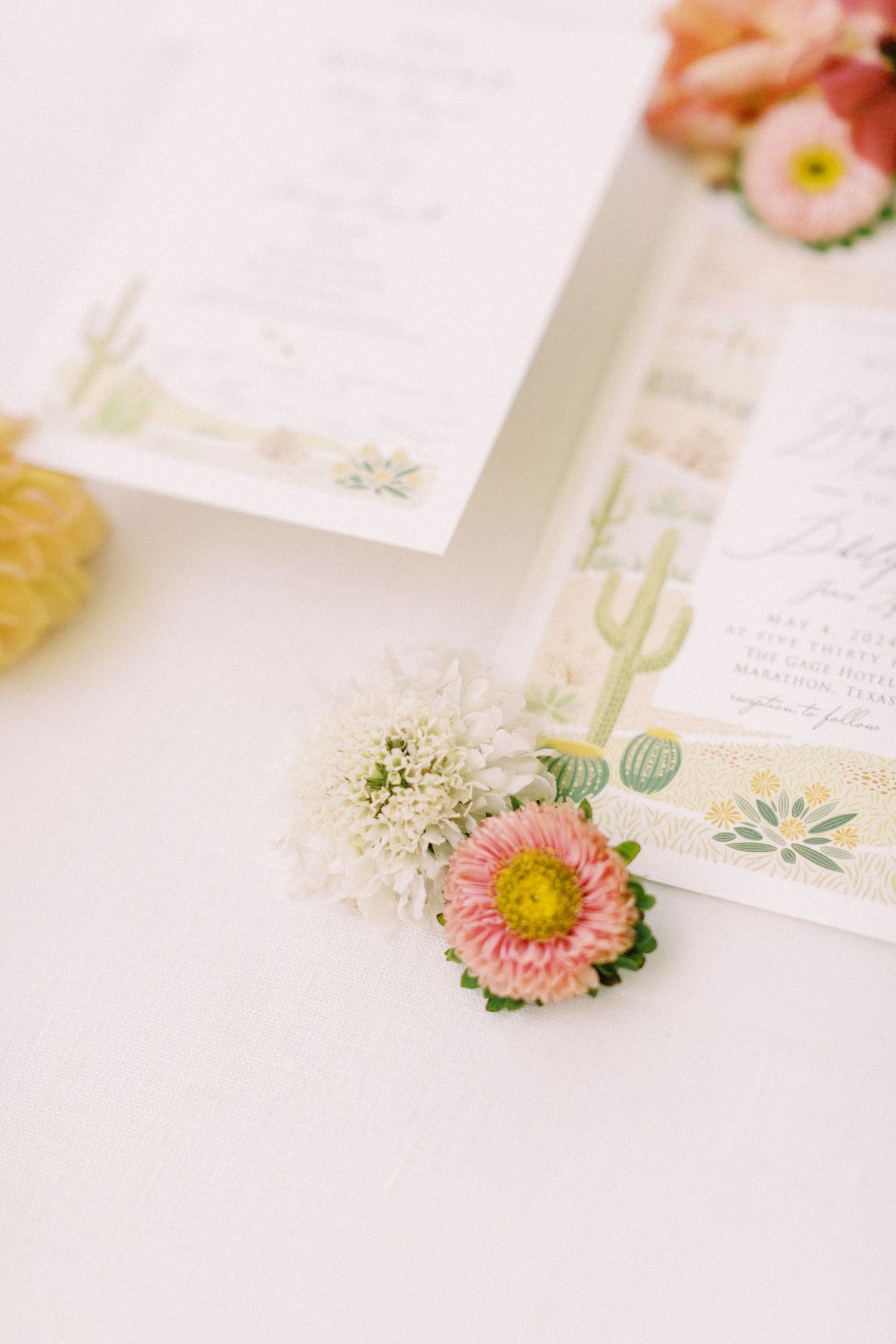 wedding invitation flatlay with florals