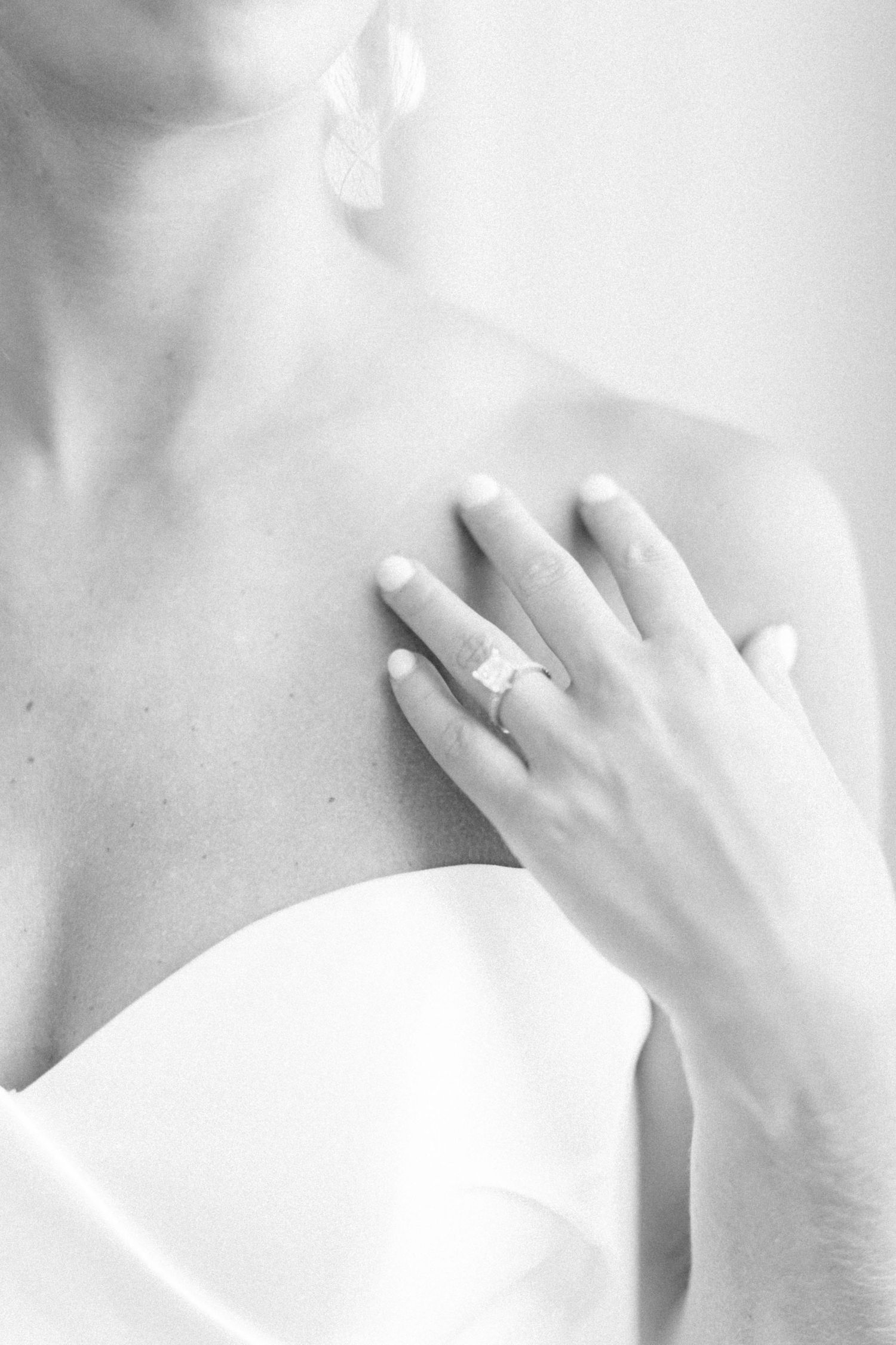 Close-up series of hands with engagement ring against white background.