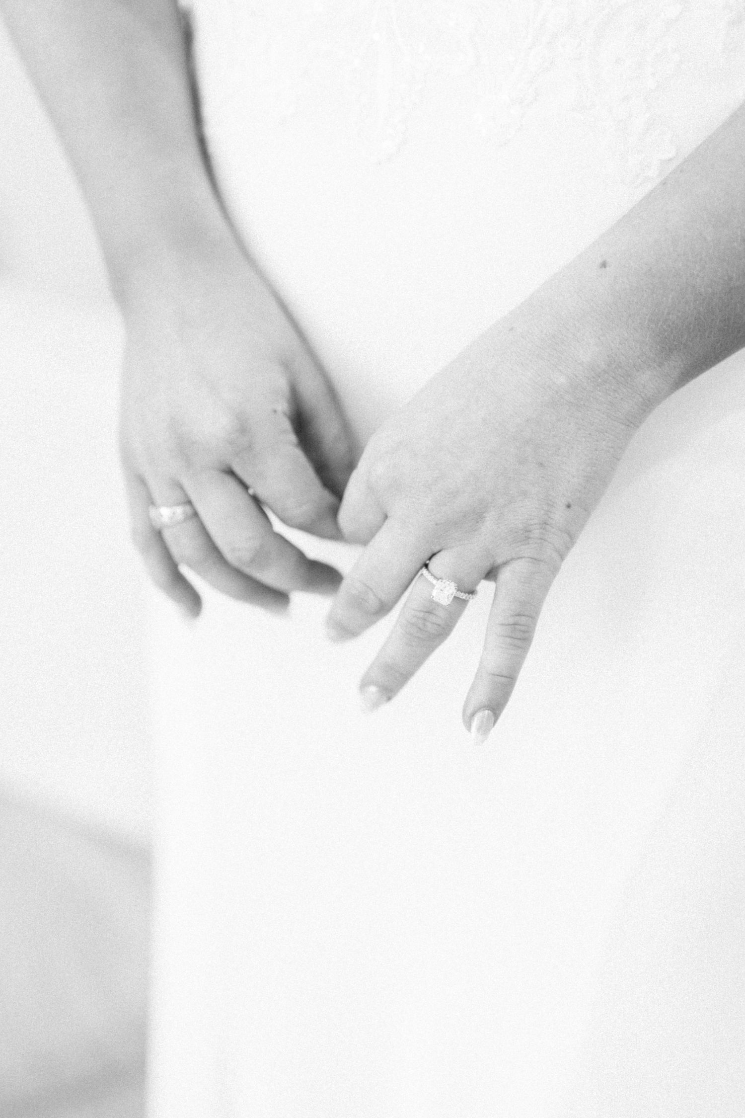 Close-up shots of hands with wedding rings against a white background.