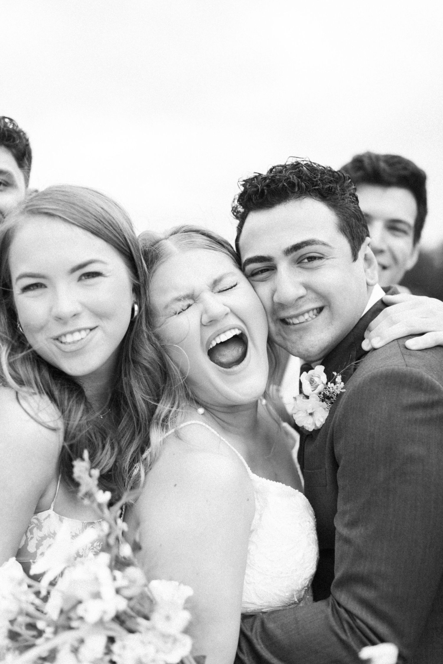 Series of candid black and white photos showing wedding party laughter and joy.