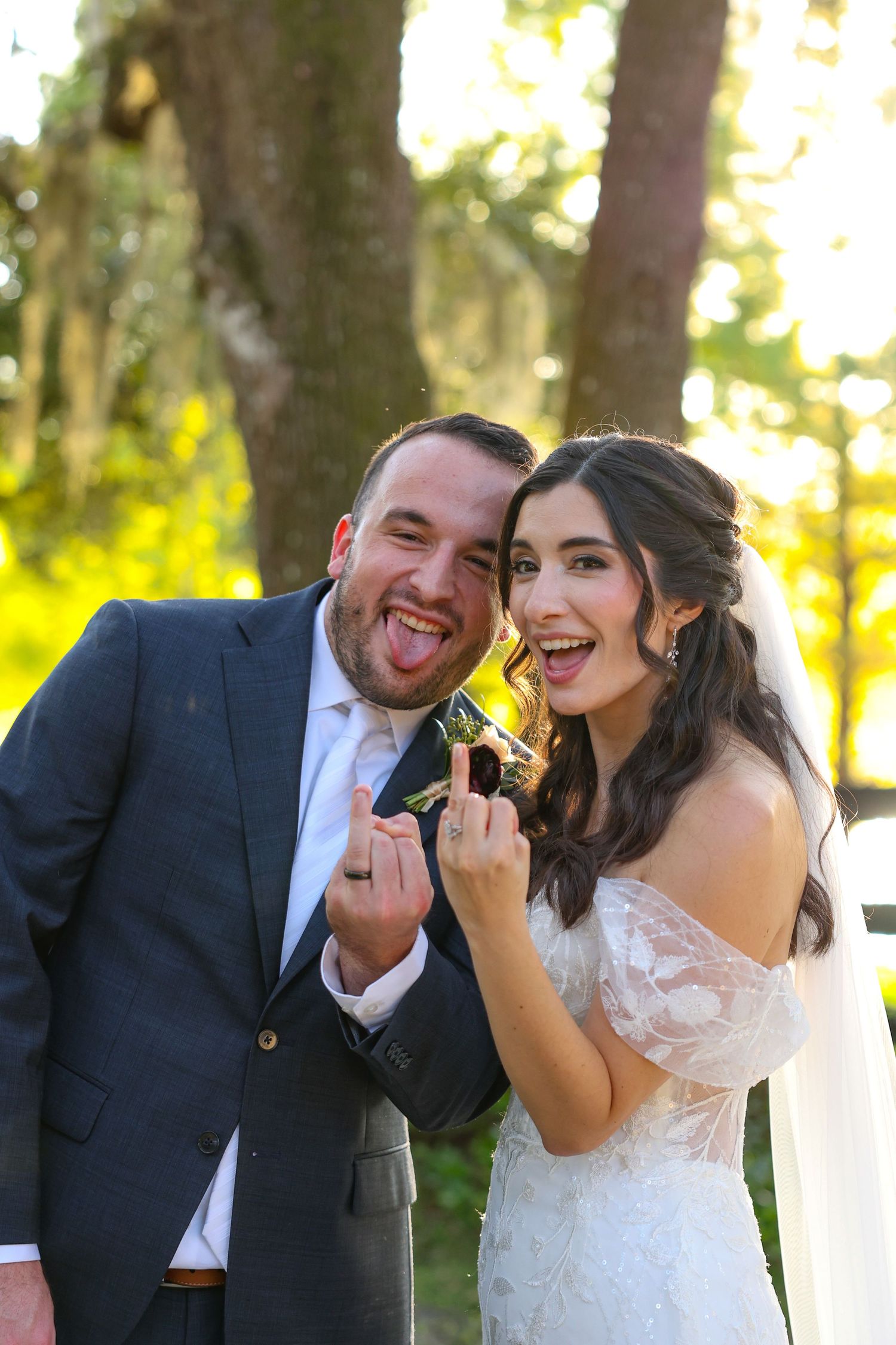 Candid joyful moments captured during outdoor wedding portraits.