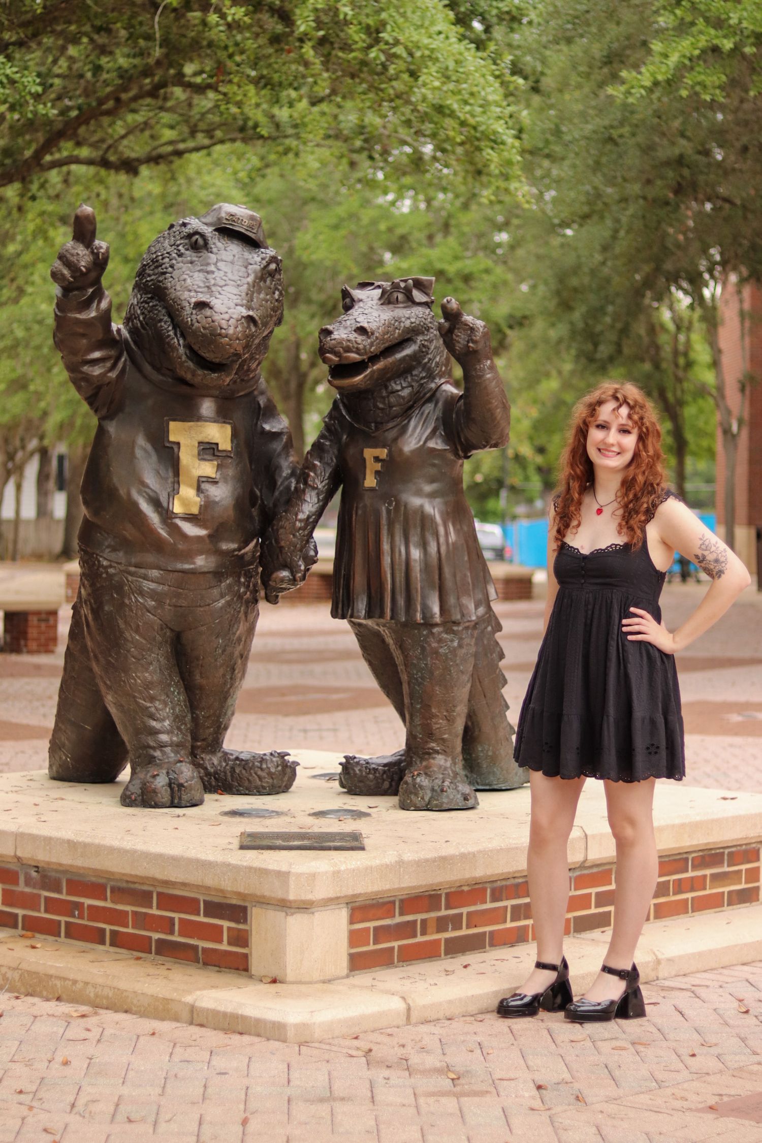 Series of poses with decorative hippo statues on brick pathway in park setting.