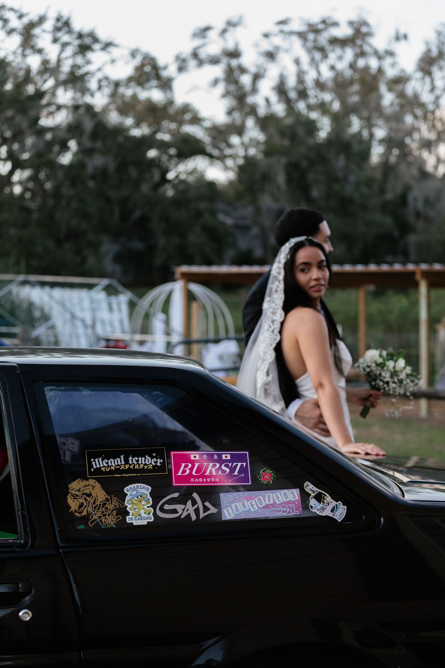 A series of photos showing a black car with decorative stickers on its side window against a natural outdoor backdrop.