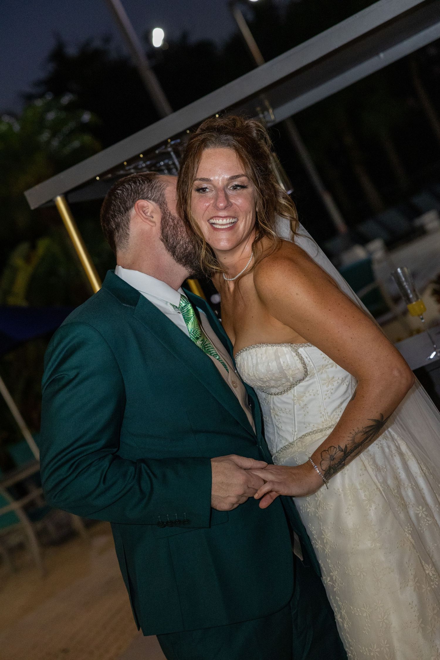 Evening reception moment captured with warm lighting and candlelit atmosphere.