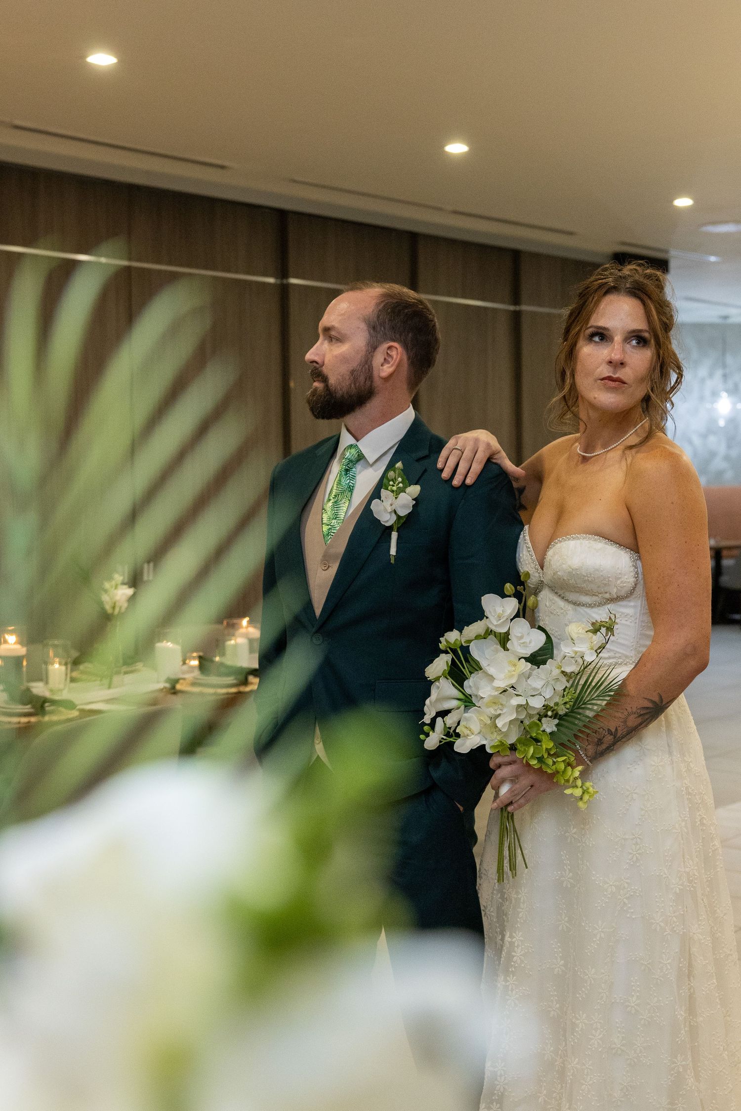 Wedding couple in formal attire sharing an intimate moment during their reception.