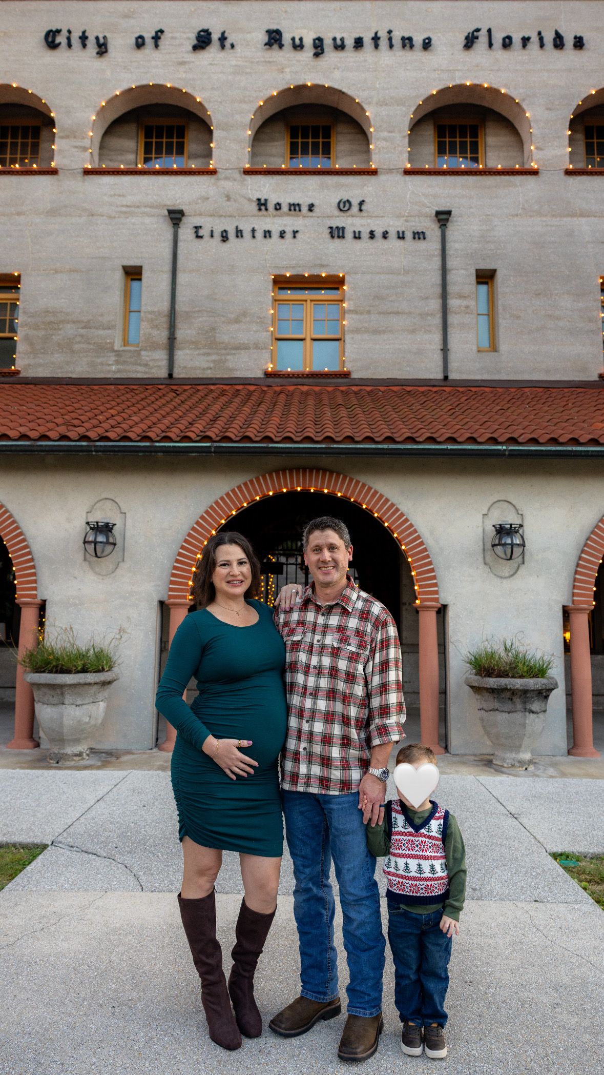 A family poses together outside the St. Augustine Florida Lightner Museum building.