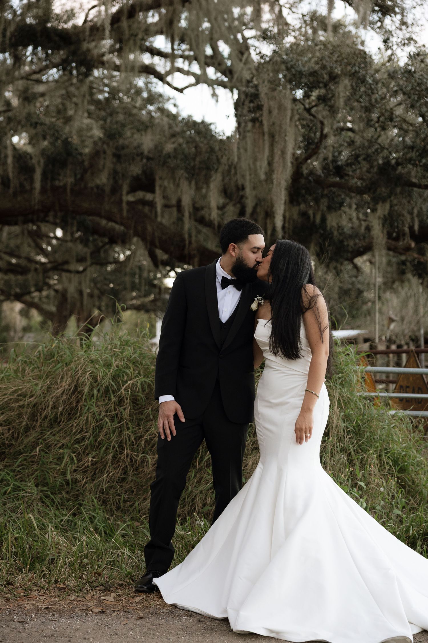 Romantic wedding portraits in a natural setting with Spanish moss trees.