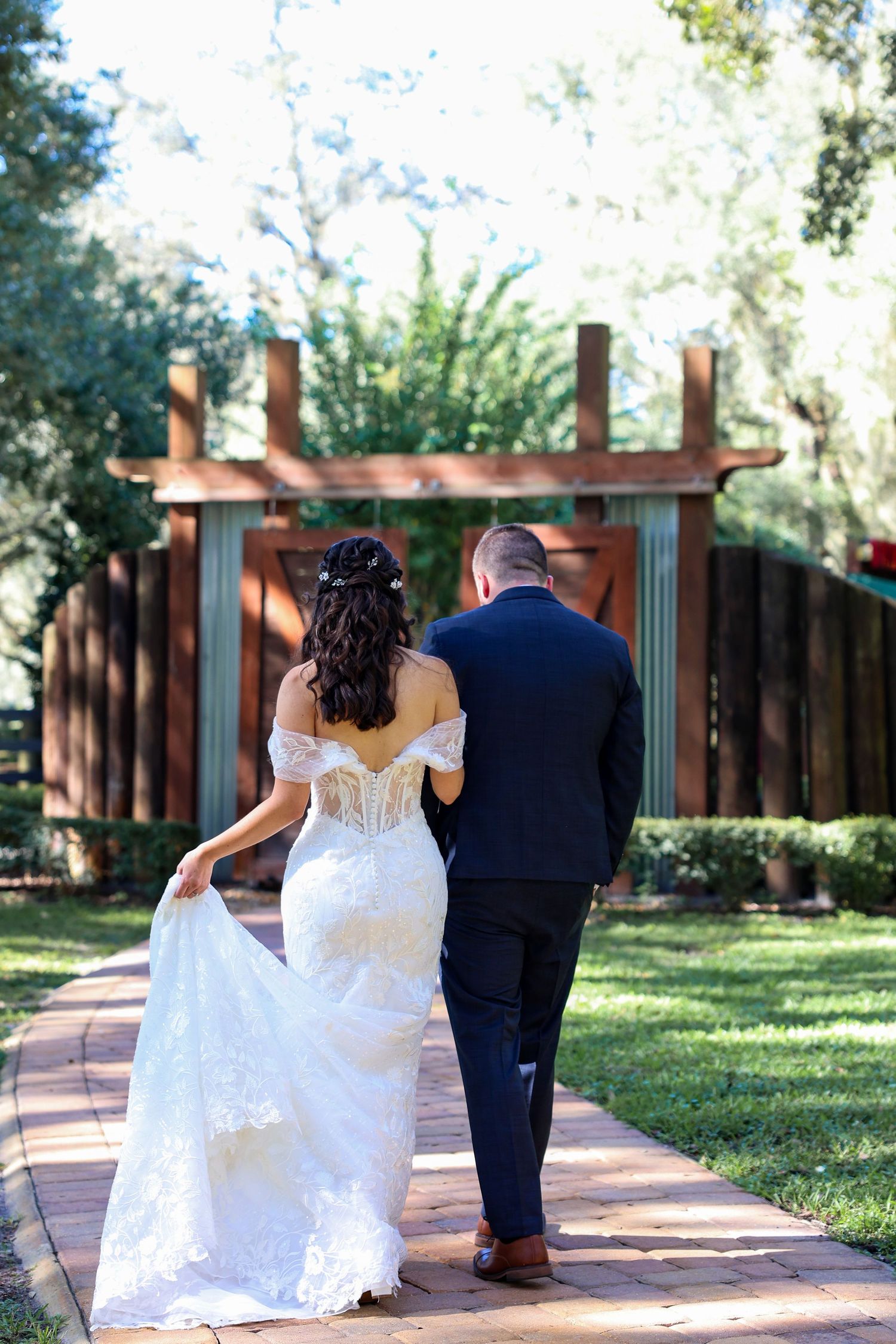 Romantic walking shots of couple along garden pathway.