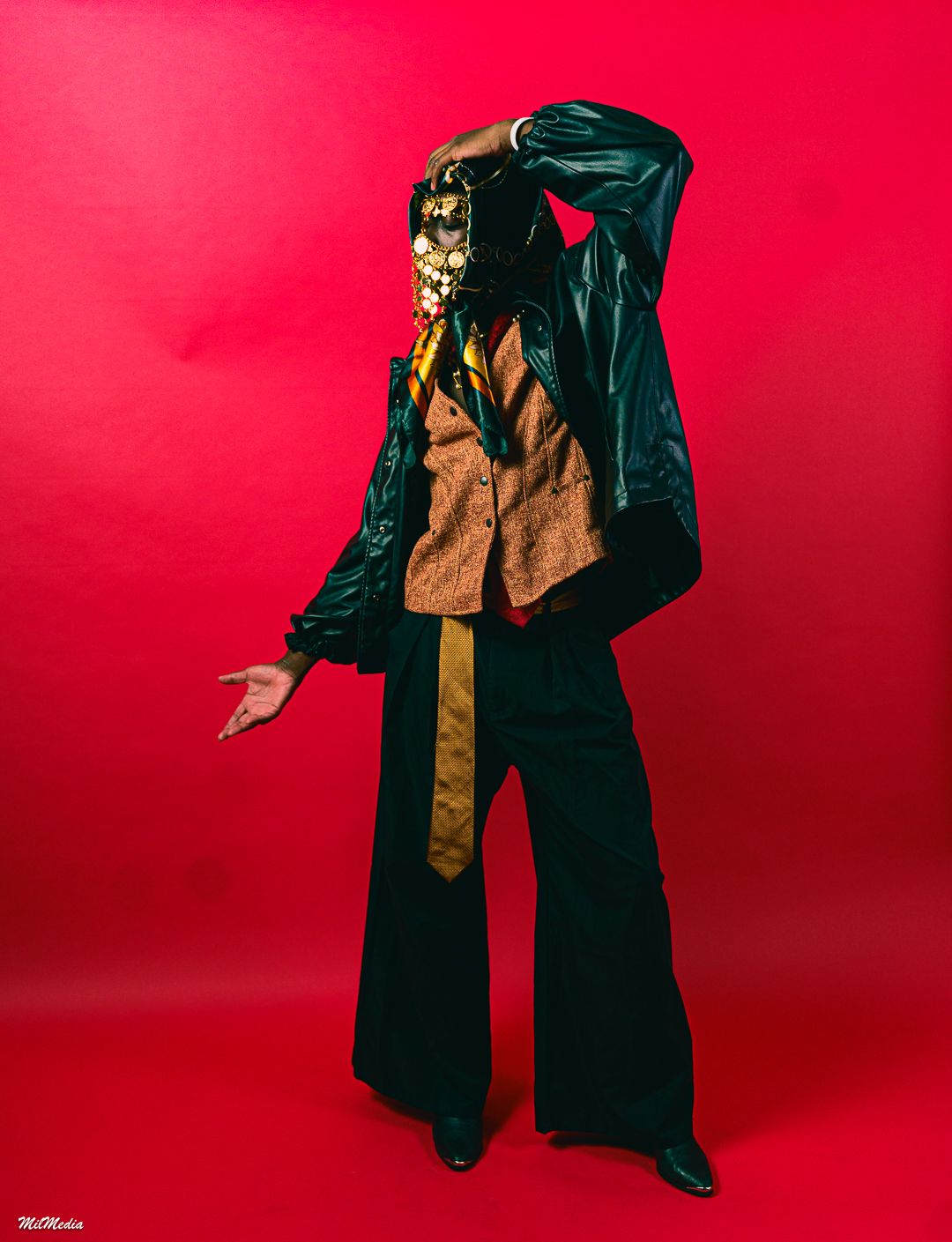 Fashion sequence against red backdrop showing flowing black and gold outfit movements.