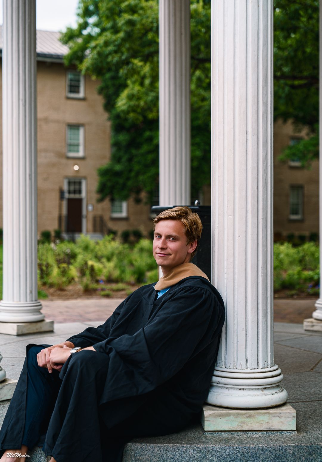 Classical white columns frame a relaxed graduation photo session at the Old Well.