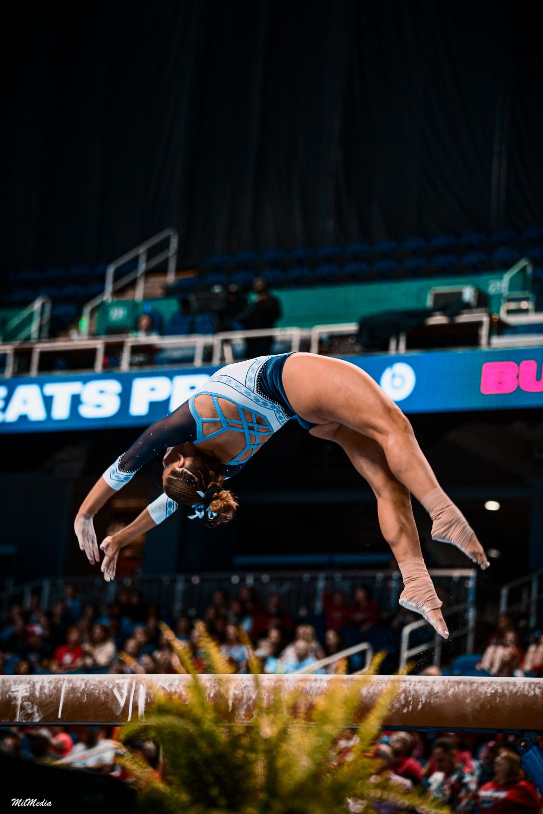 Sequence of a gymnast executing a flip on the balance beam in competition.