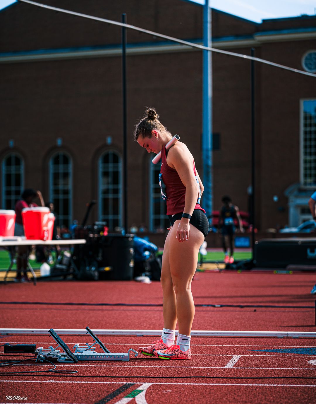 Athlete in athletic wear preparing to start race on outdoor track during the ACC Track and Field Championships.