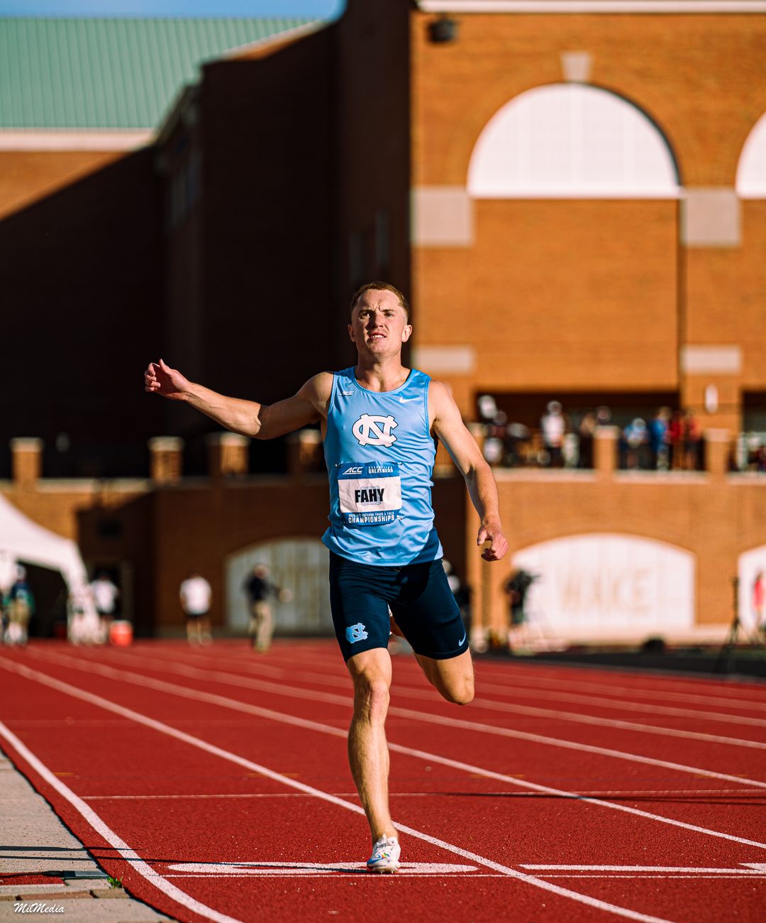 Track athlete sprints powerfully down lane during competitive race on outdoor track during the ACC Track and Field Championships.