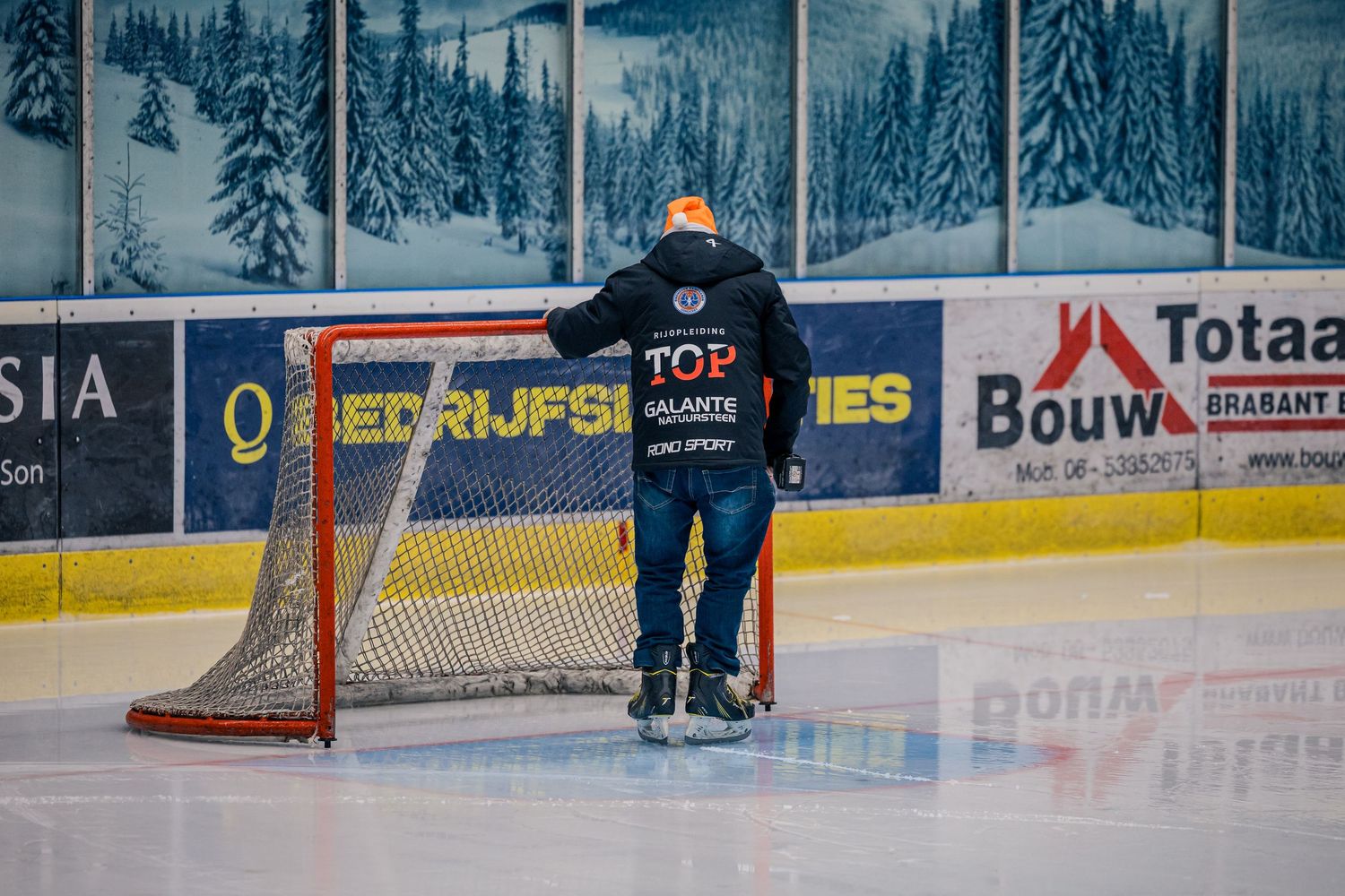 Materiaalman controleert het ijs en het doel tijdens de rust van de ijshockeywedstrijd bij de Eindhoven Kemphanen