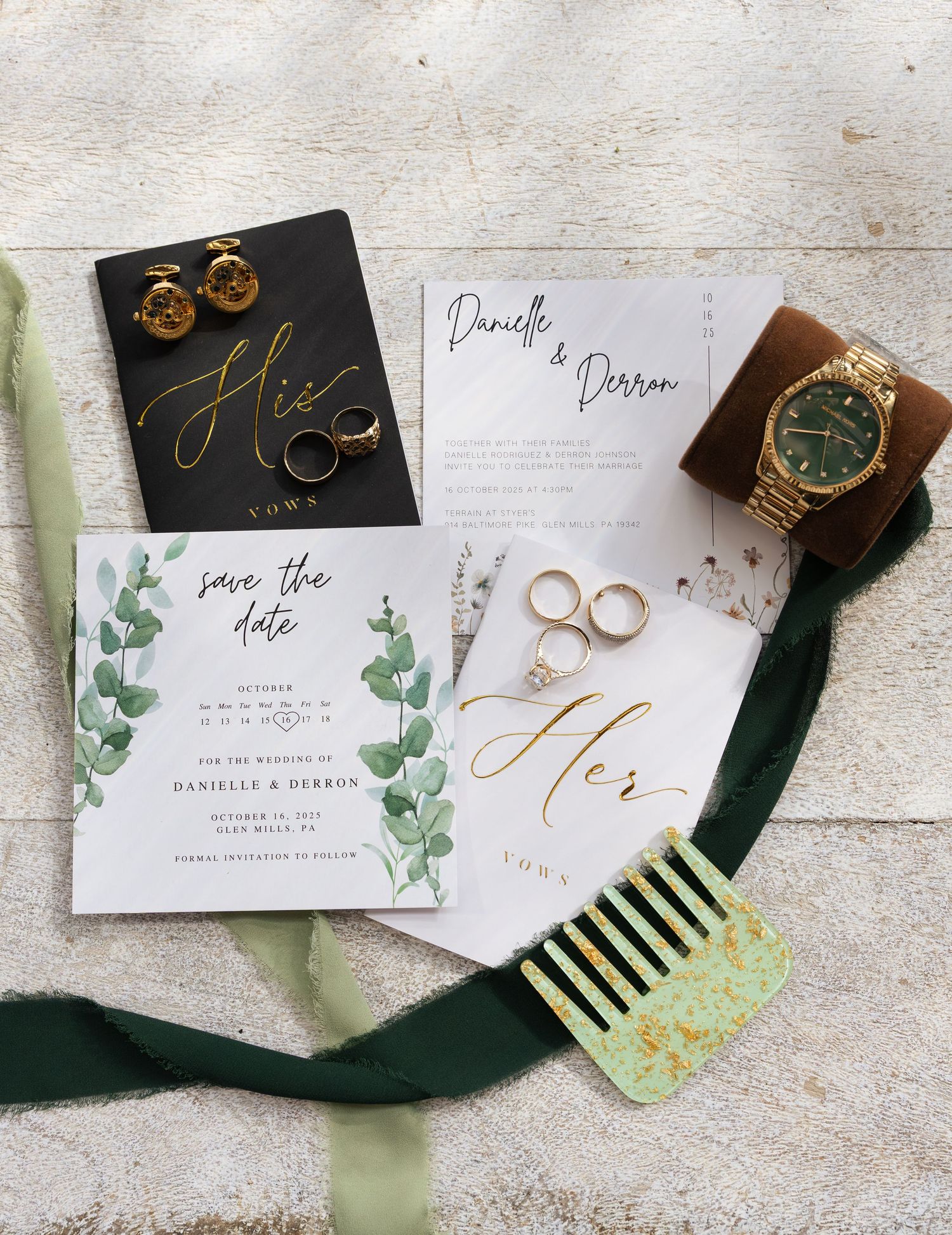 Wedding stationery flat lay with eucalyptus leaves, rings, and black velvet ribbon on white background.