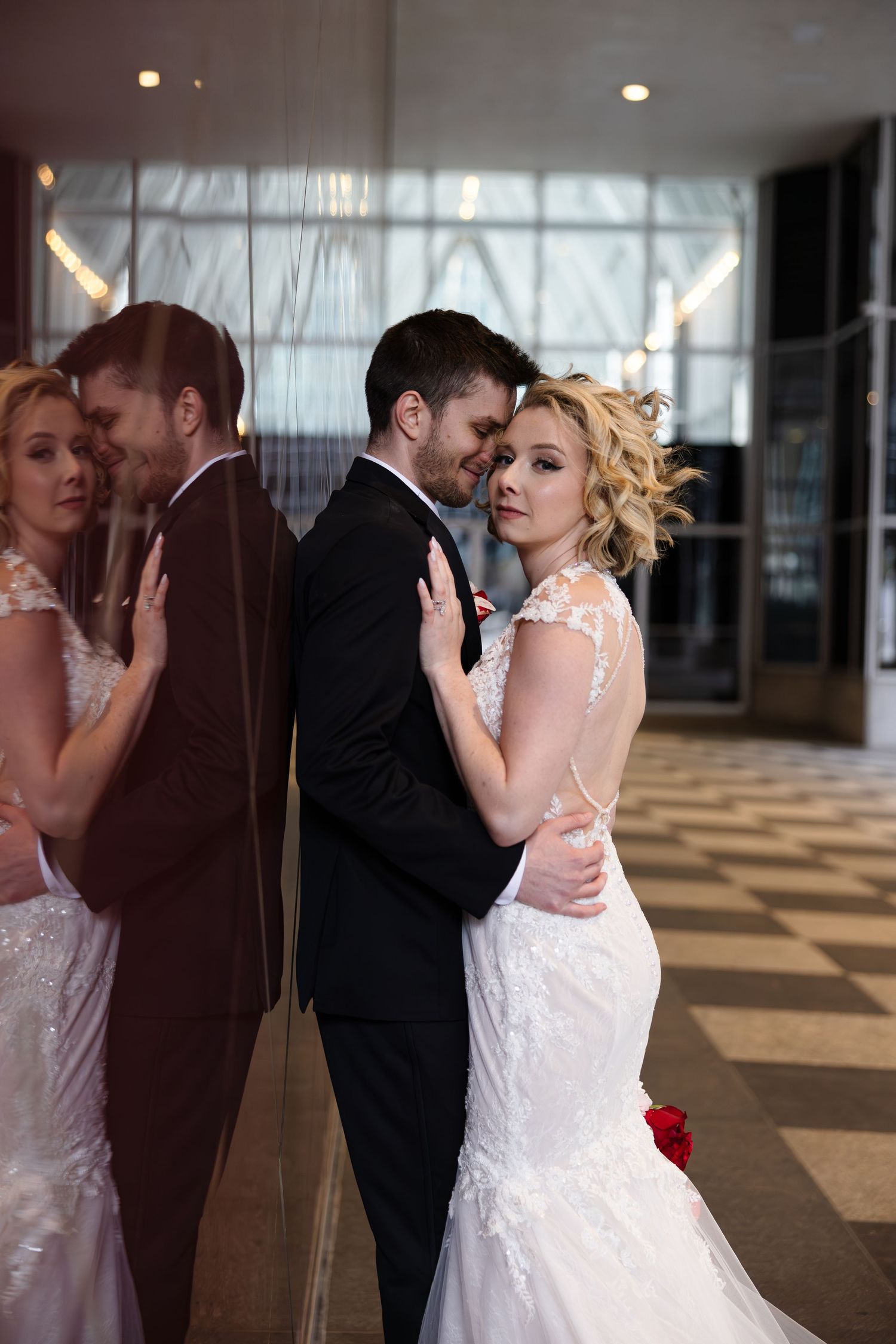 Romantic wedding portrait captured outside of the Wintergarden PPG venue with reflective surfaces.