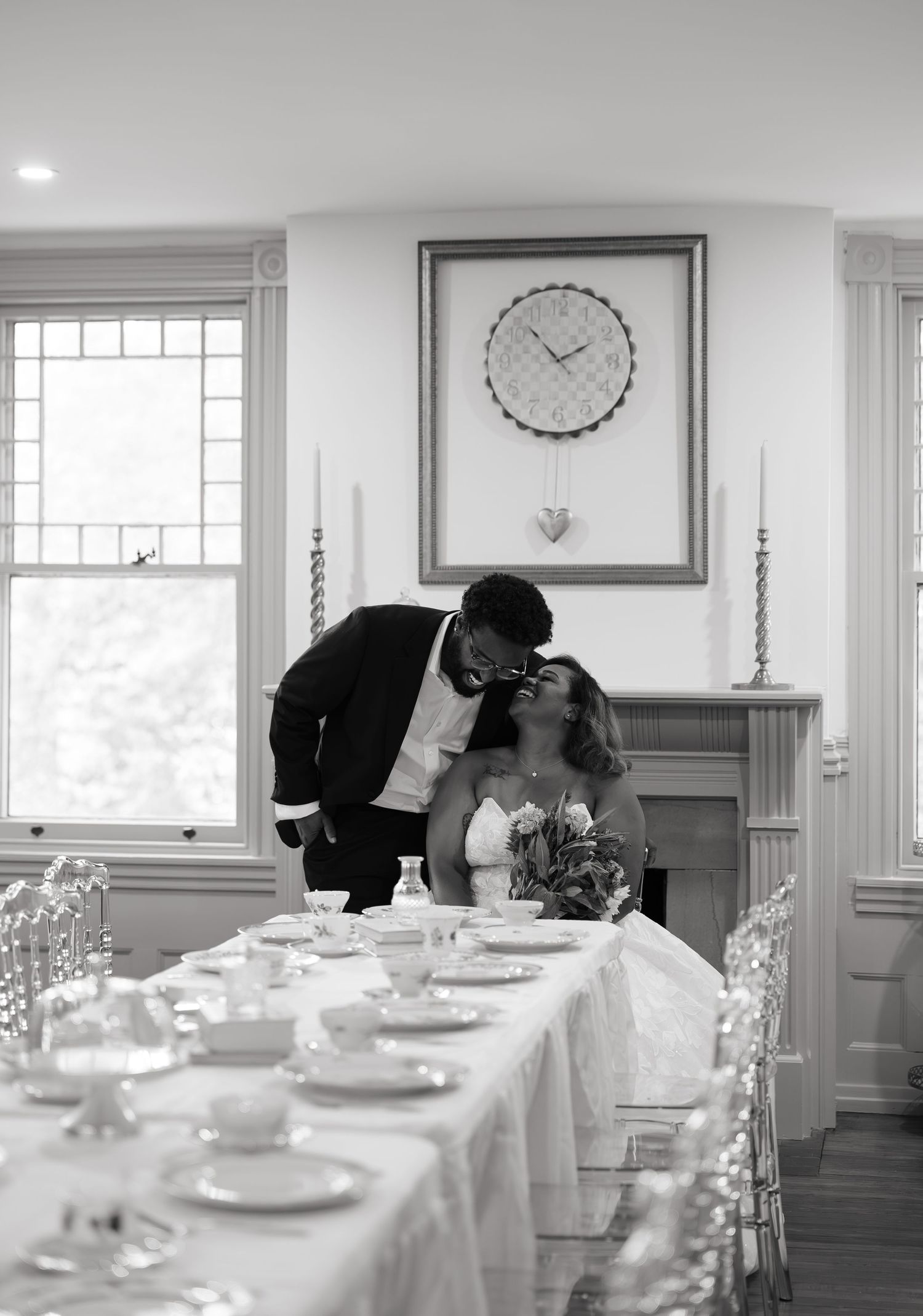 Black and white wedding photos of couple at formal dining table setting.