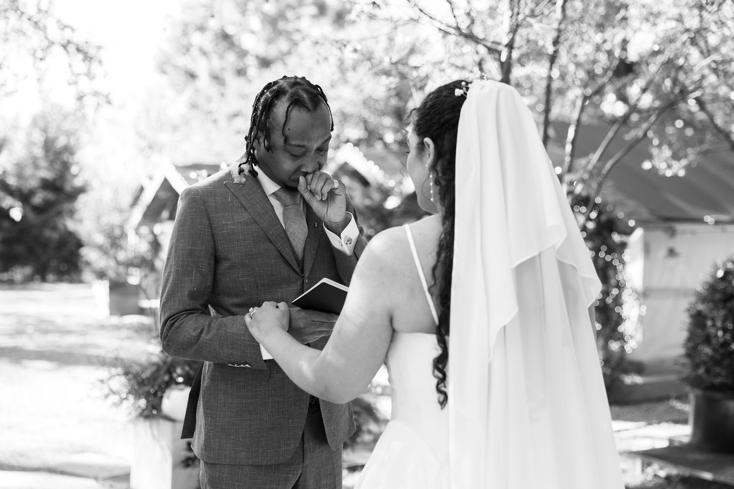 An emotional black and white wedding photo during the bride and grooms private vows.