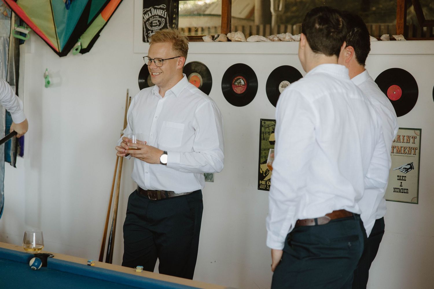 Groom and groomsmen playing pool before wedding ceremony in the Eastern Cape