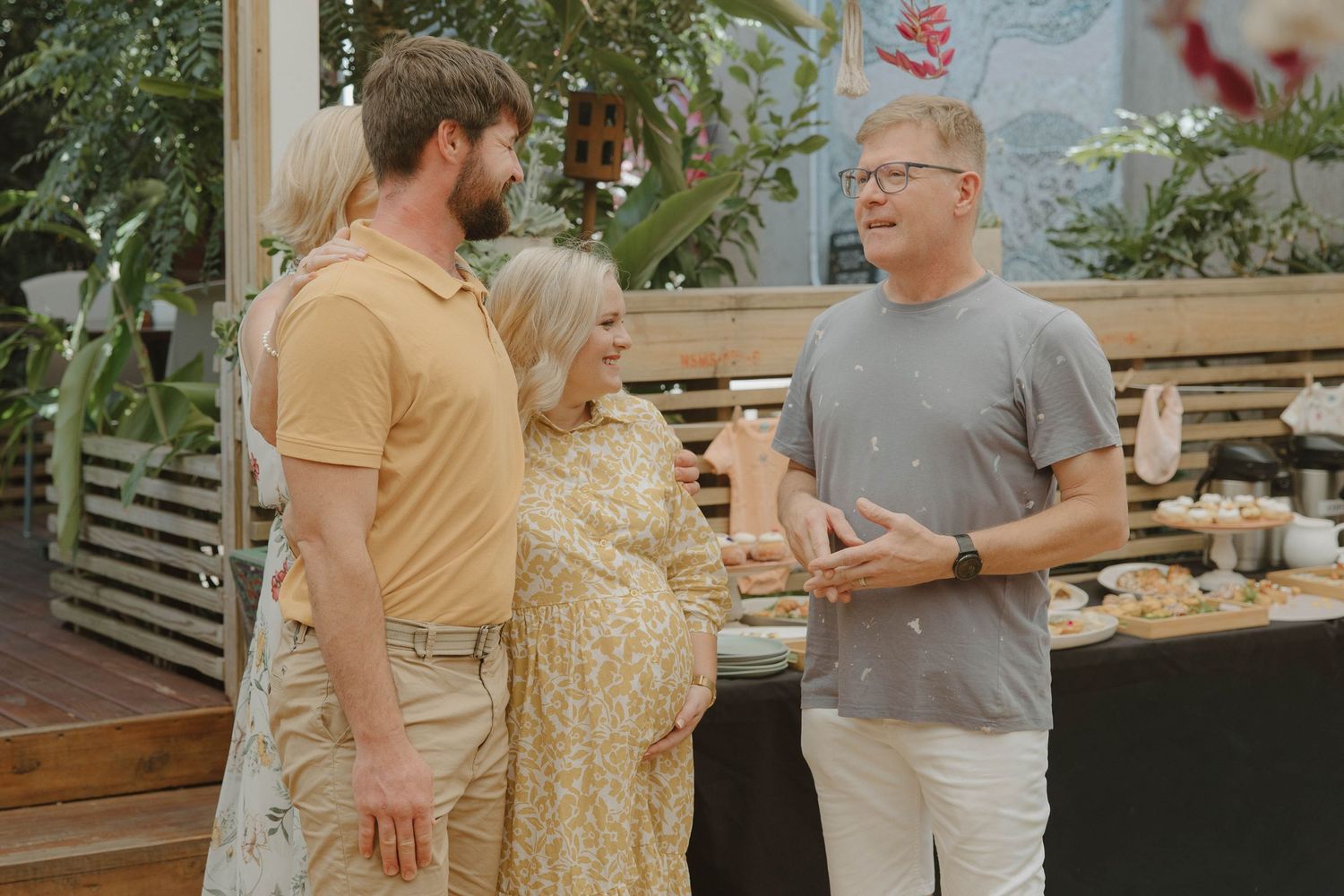 Candid photography of prayer over parents-to-be at baby shower in Jeffreys Bay