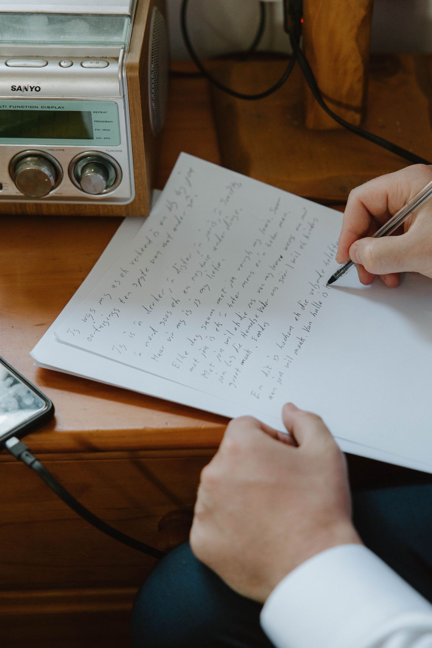 Close up photo of groom writing vows