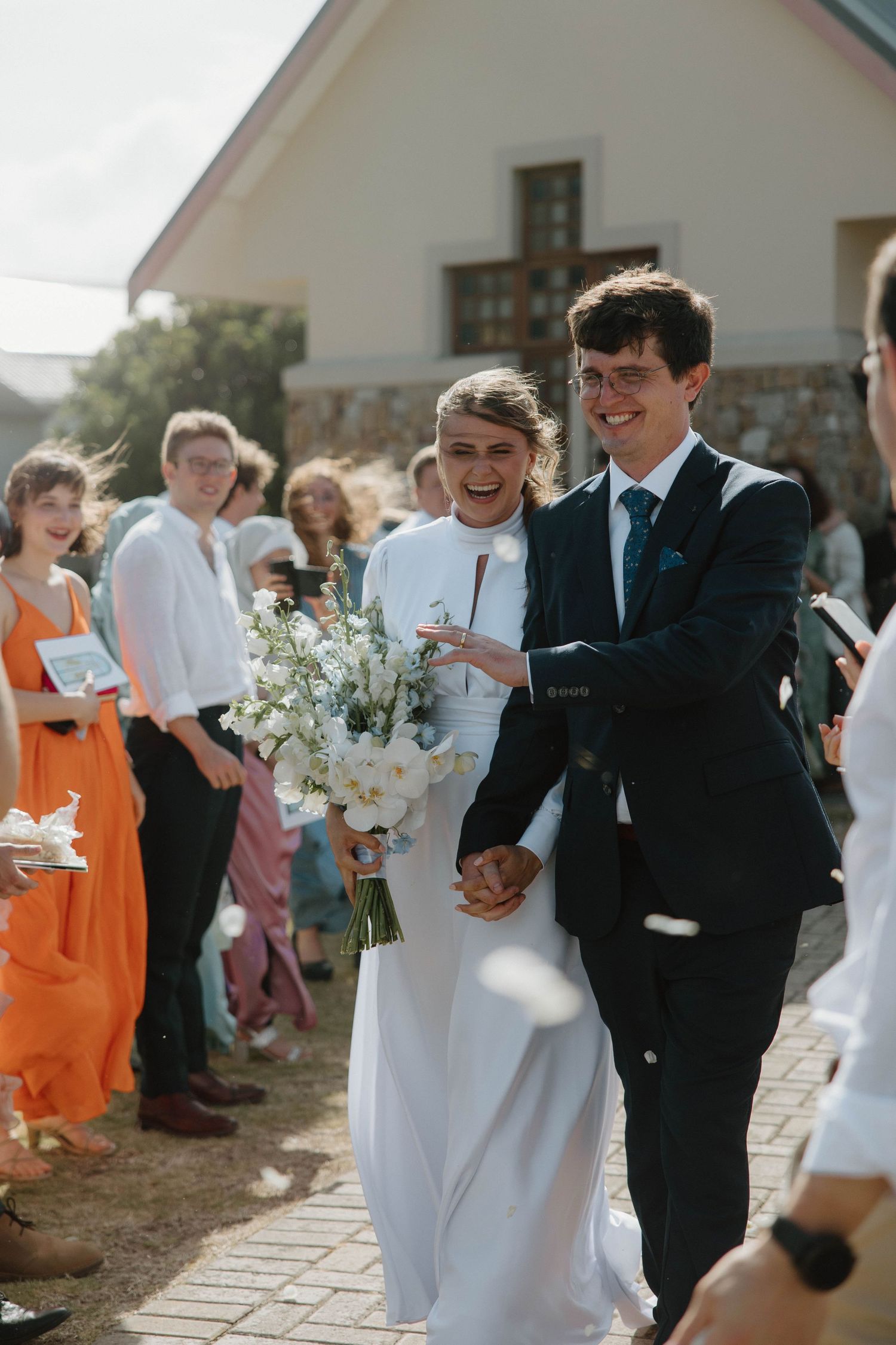 Bride and groom walking hand in hand after wedding ceremony in chapel in Eastern Cape