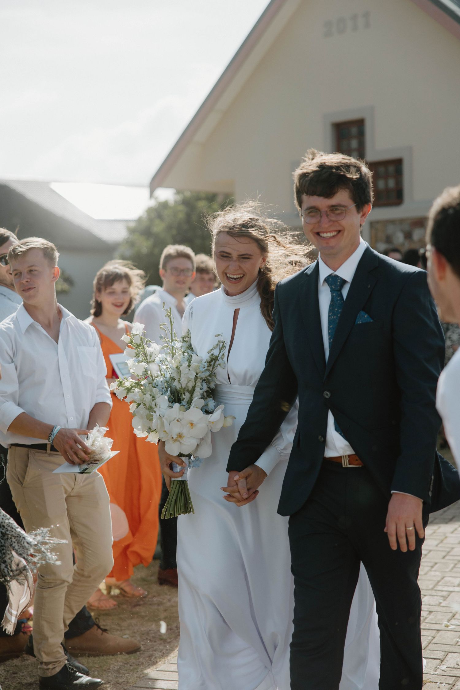 Bride and groom walking hand in hand after wedding ceremony in chapel in Eastern Cape