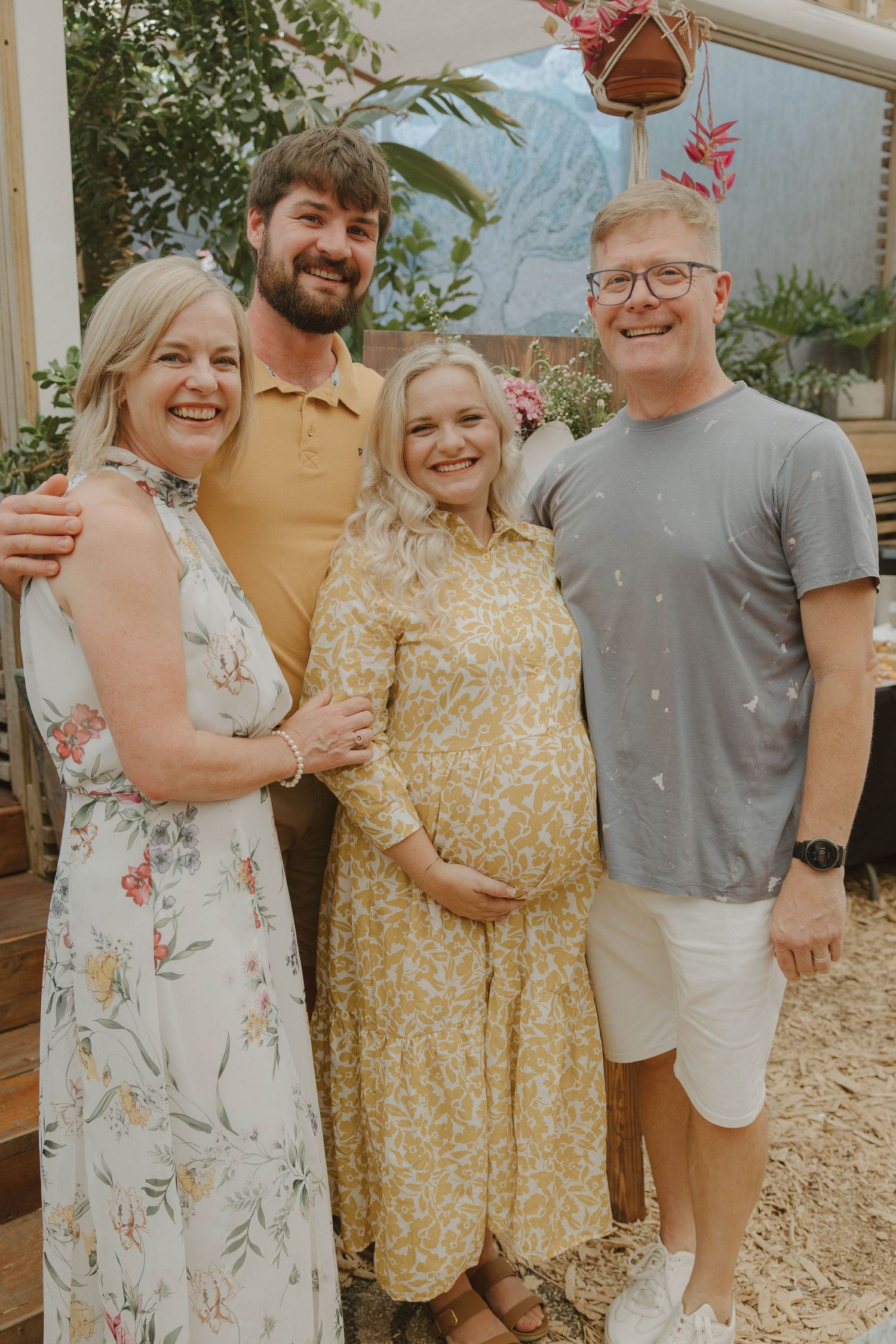 Emotional hug between mom-to-be and family at baby shower