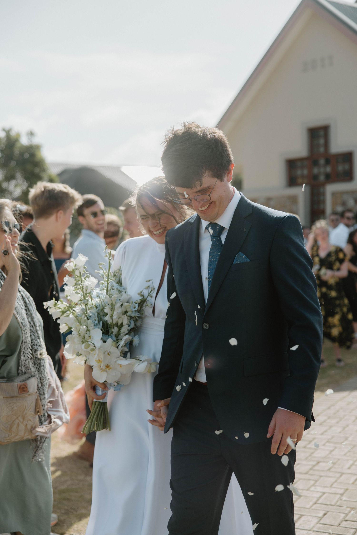 Bride and groom walking hand in hand after wedding ceremony in chapel in Eastern Cape