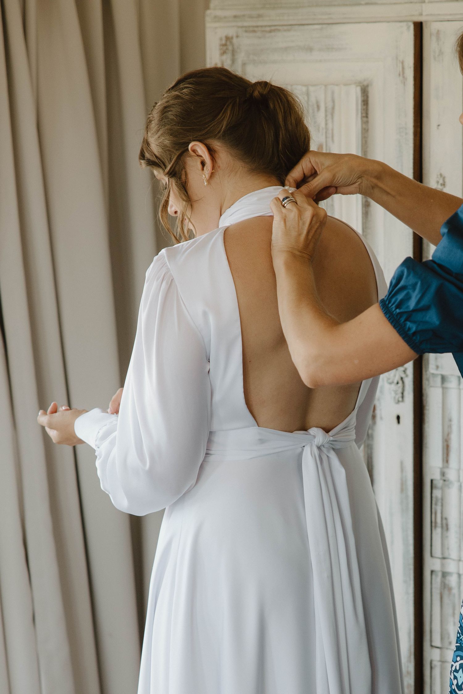 Bride getting dressed on wedding day
