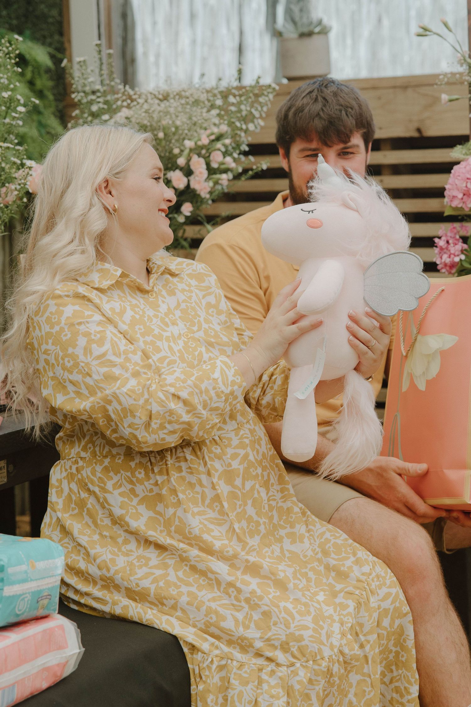 Mom-to-be opening gifts at intimate baby shower in Jeffrey’s Bay