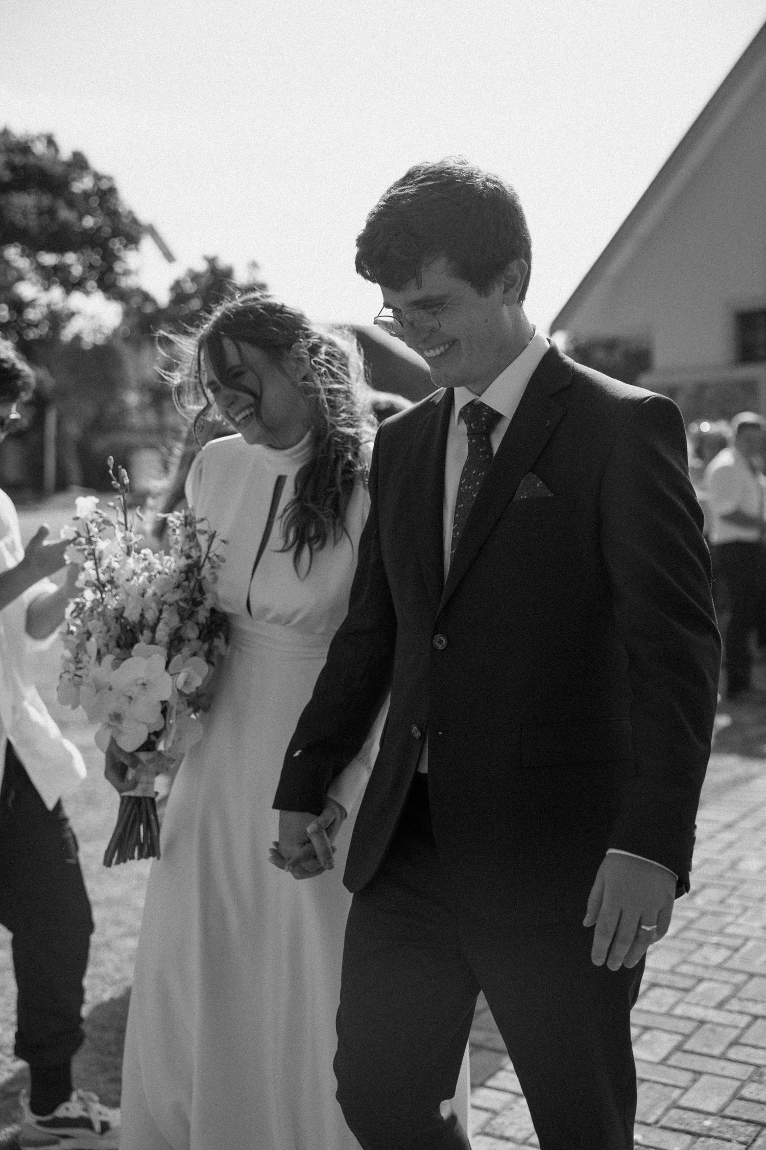 Newlyweds walking hand in hand after wedding ceremony in chapel in Eastern Cape