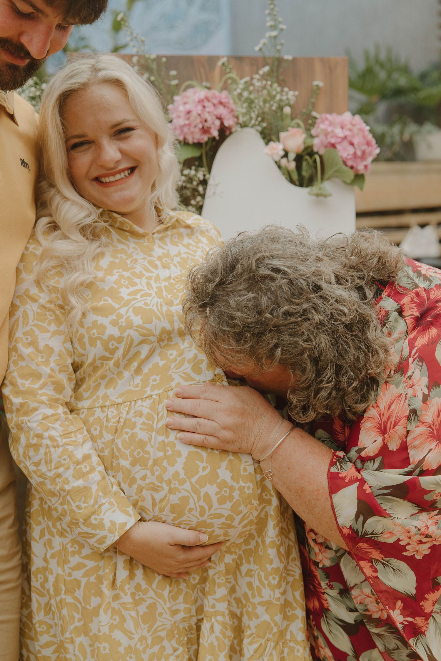 Candid moment between mom-to-be and family at baby shower