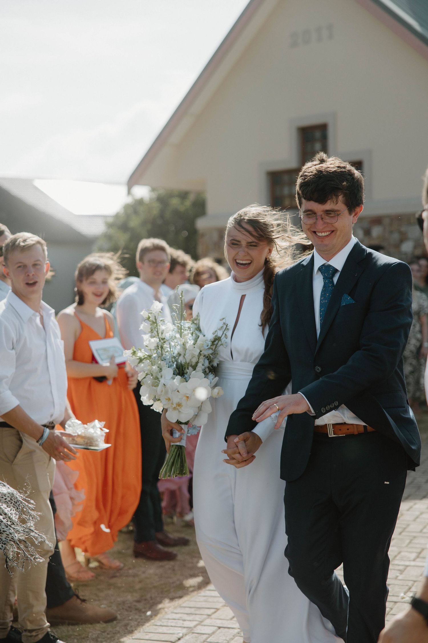 Bride and groom walking hand in hand after wedding ceremony in chapel in Eastern Cape