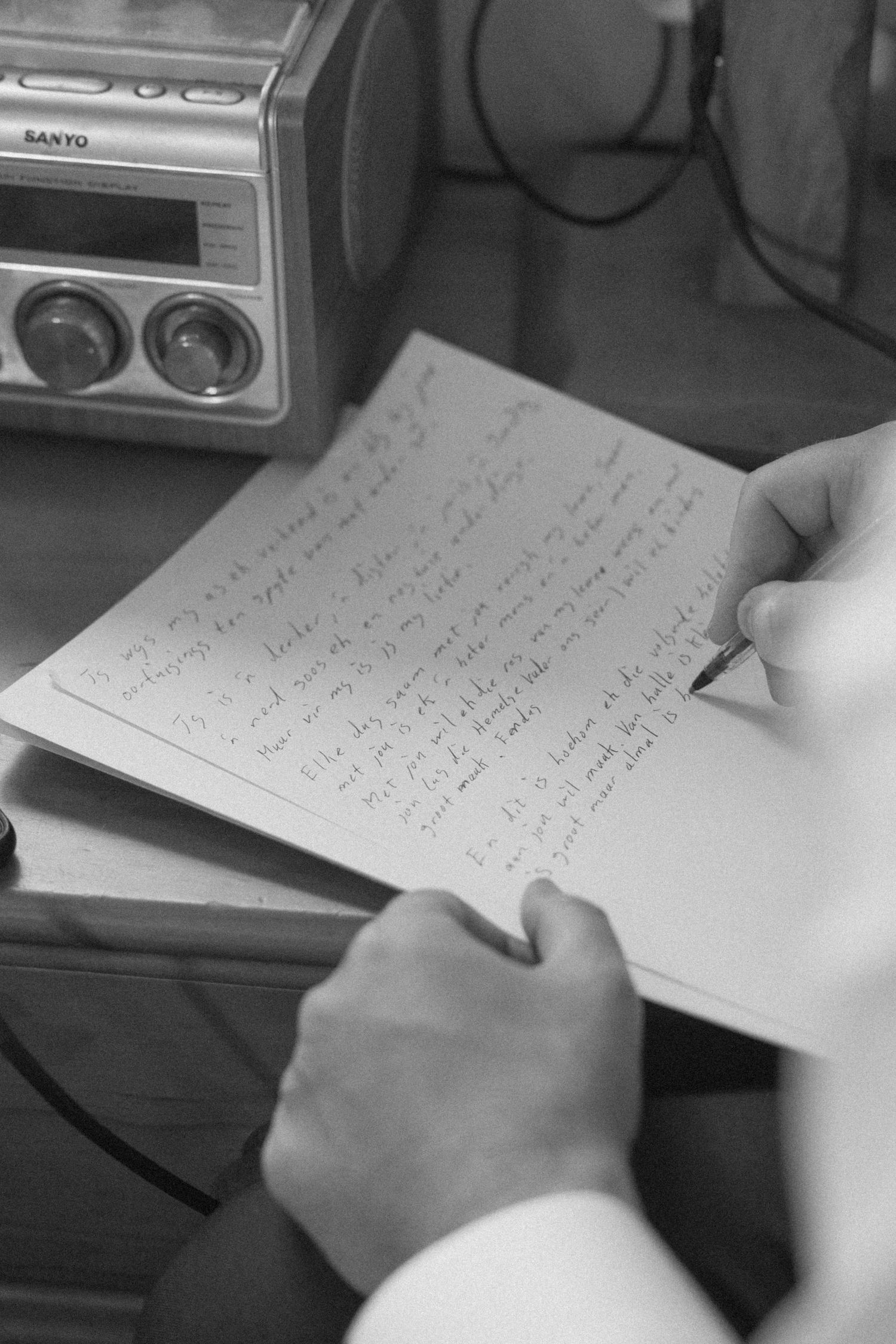 Close up photo of groom writing vows on wedding morning