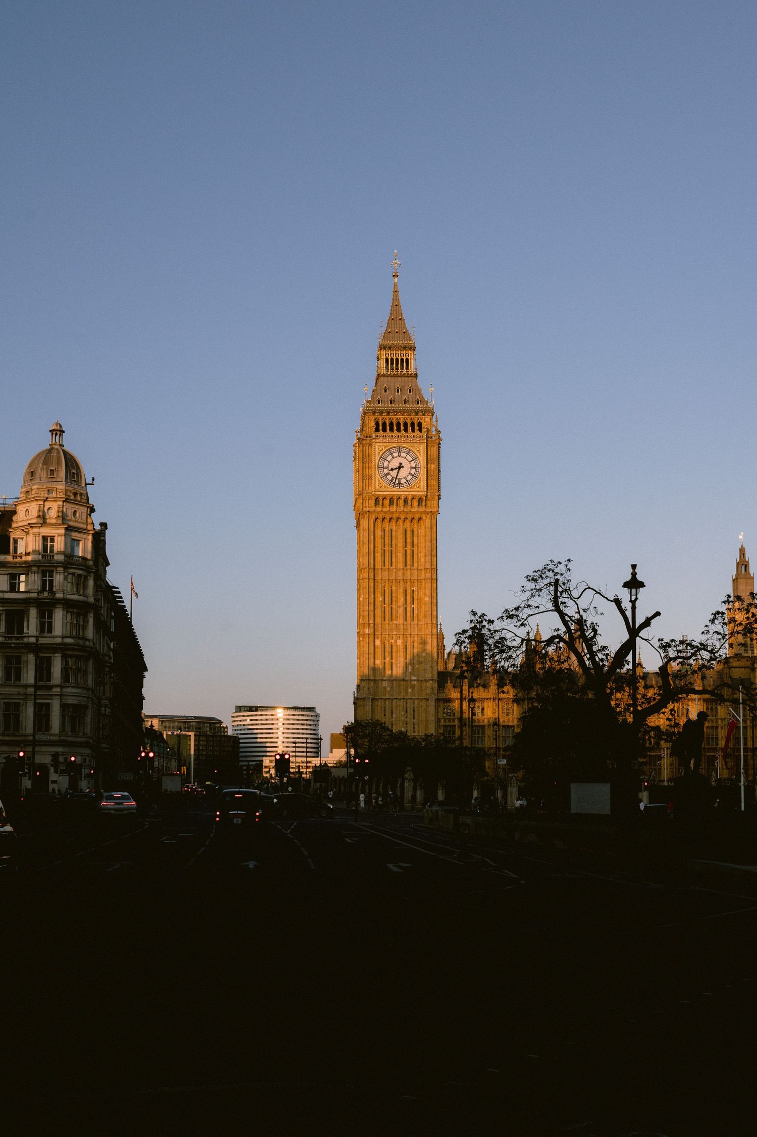 London's iconic Big Ben and Houses of Parliament silhouetted against a dramatic sunset sky.