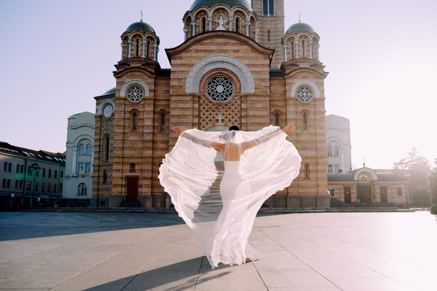 A panoramic series of church exterior shots with a flowing white dress creating an ethereal effect in the sunlight.
