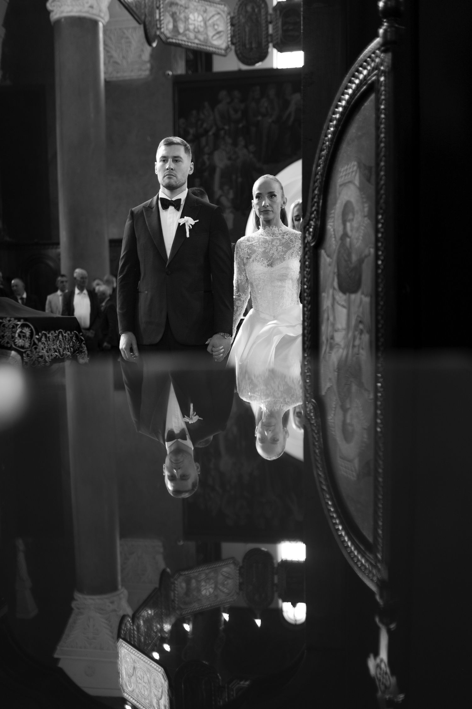 Artistic black and white reflections of a wedding couple in vintage mirrors.