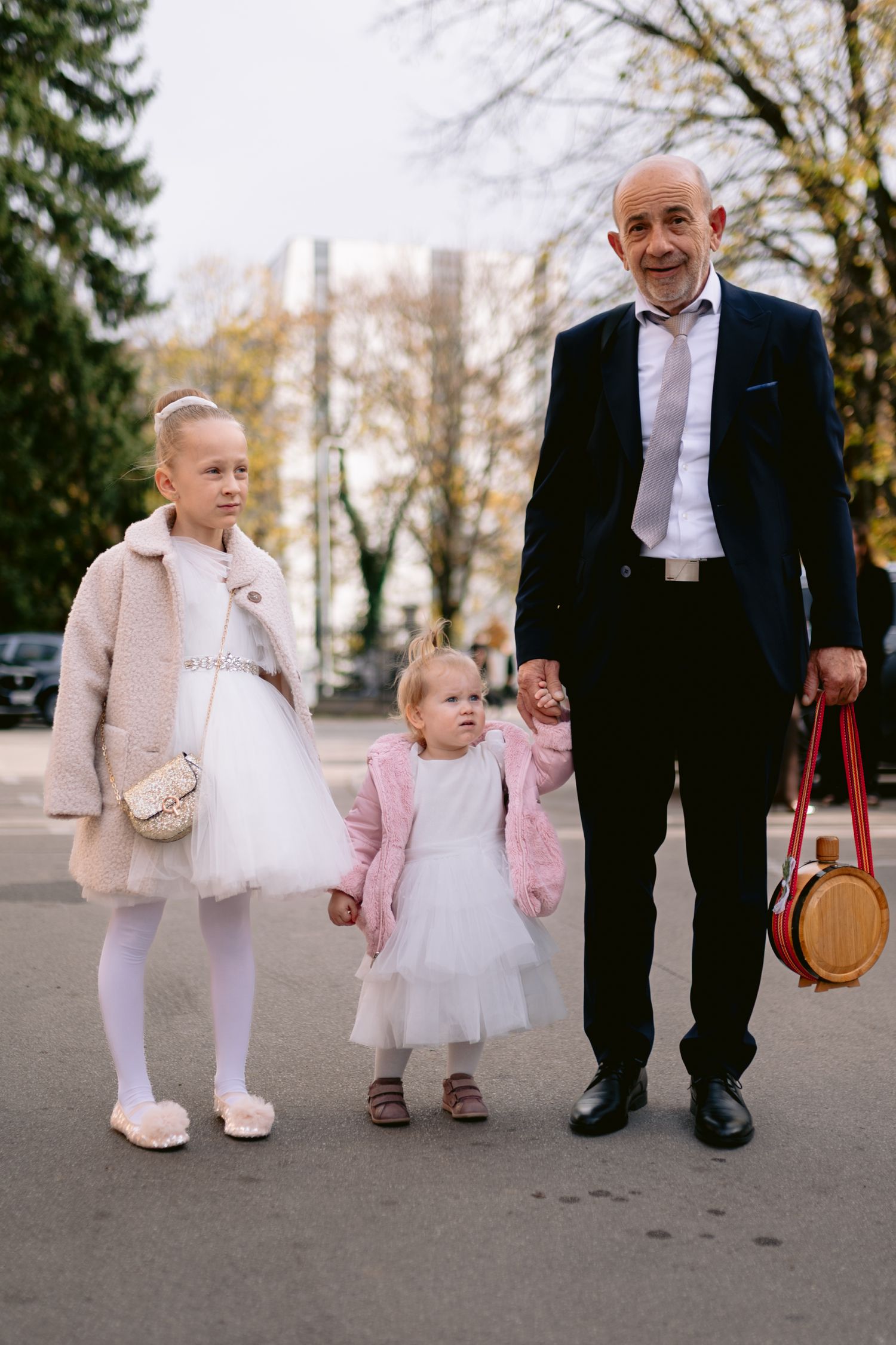 A series of photos showing feet and legs of people in formal attire, with a small child in a white tutu dress.