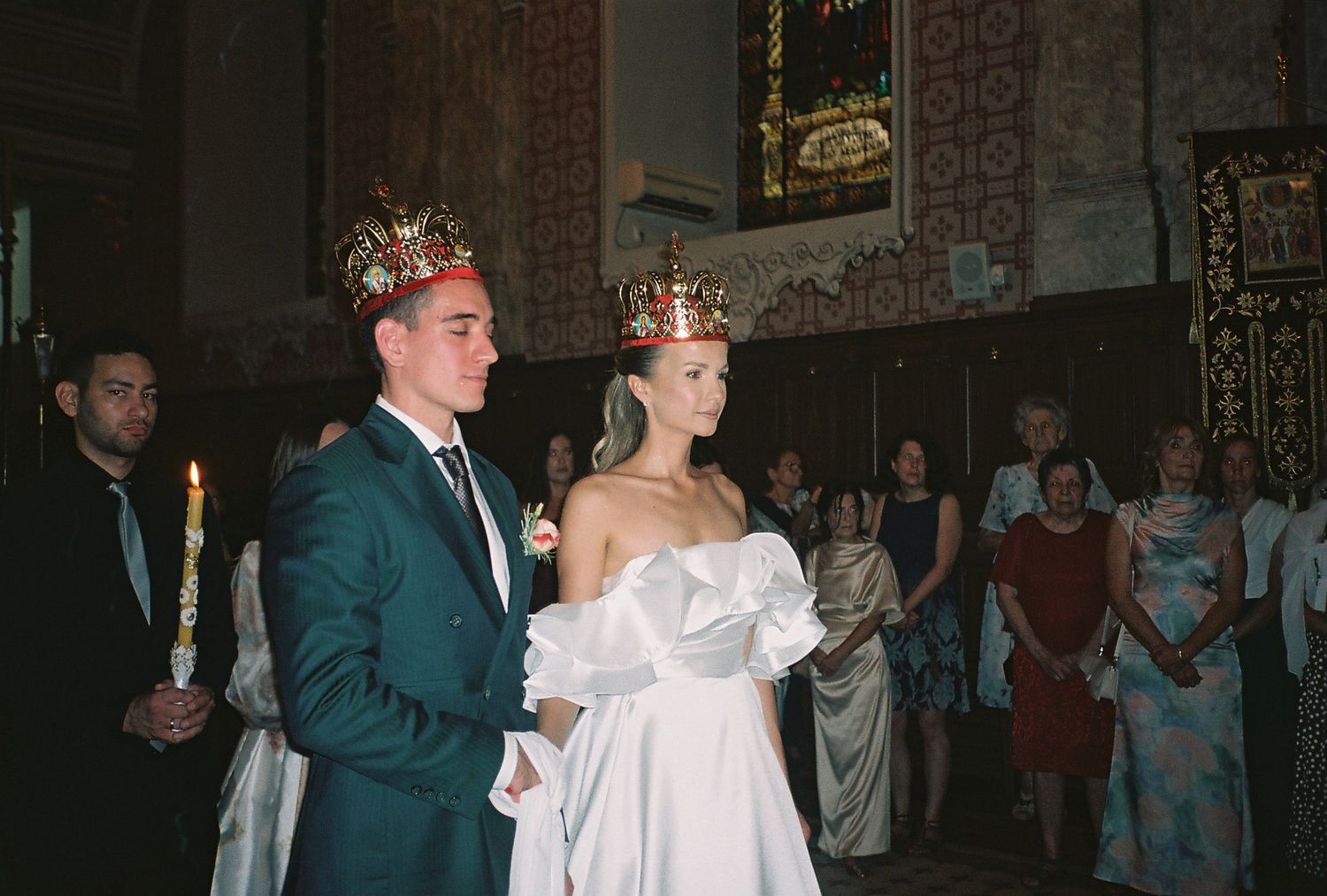 A couple in formal attire shares a dance together during a wedding celebration in an elegant venue.