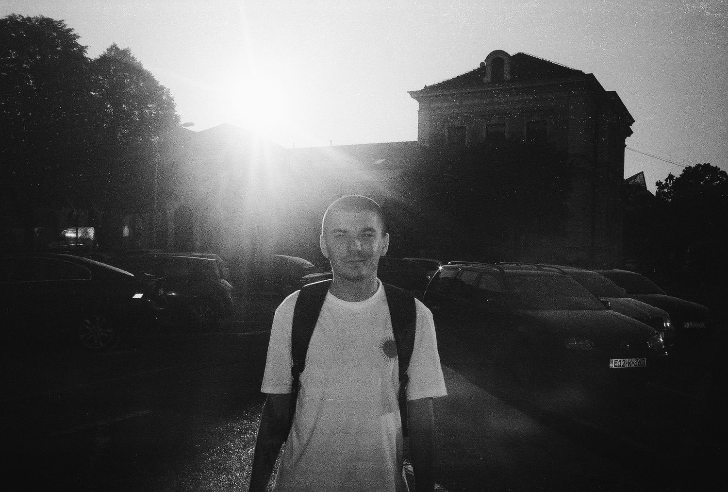 A black and white film strip showing a sequence of silhouetted figures against a bright sky at sunset.