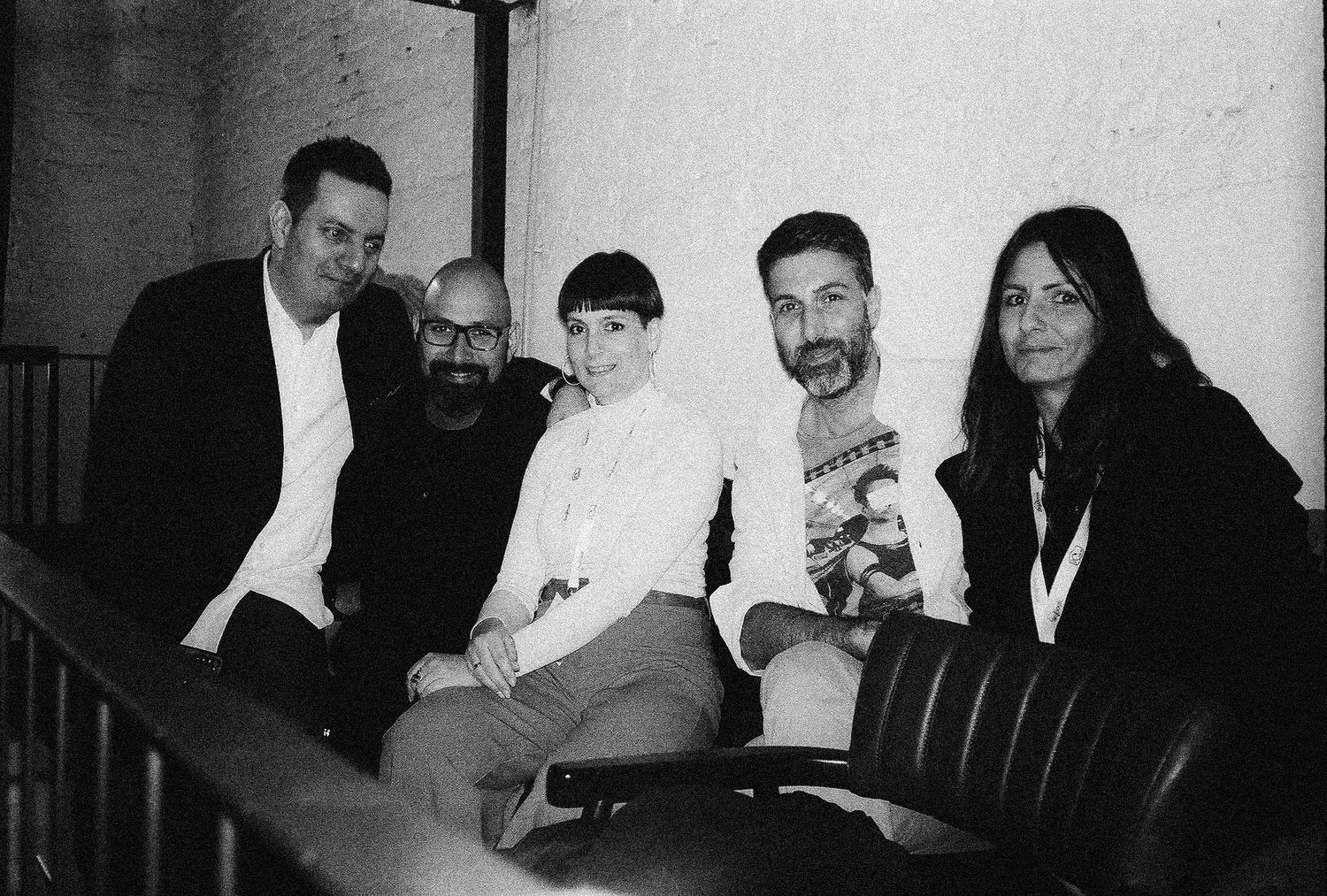 A black and white photo collage shows several group photos of people gathered together in casual settings.
