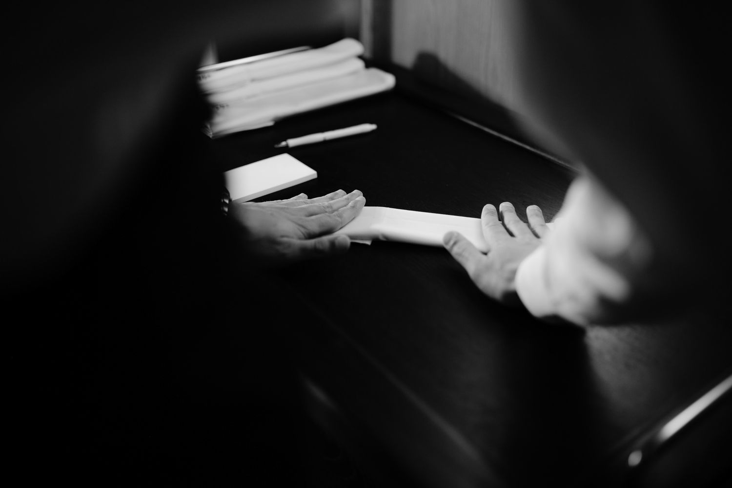 Dimly lit restaurant scene with glassware in black and white.