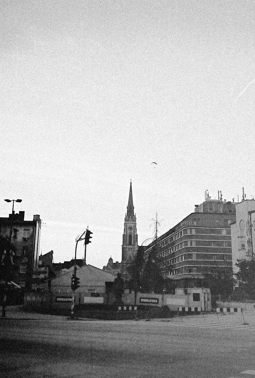 A series of black and white urban landscape photos showing buildings and streets in what appears to be a European city.