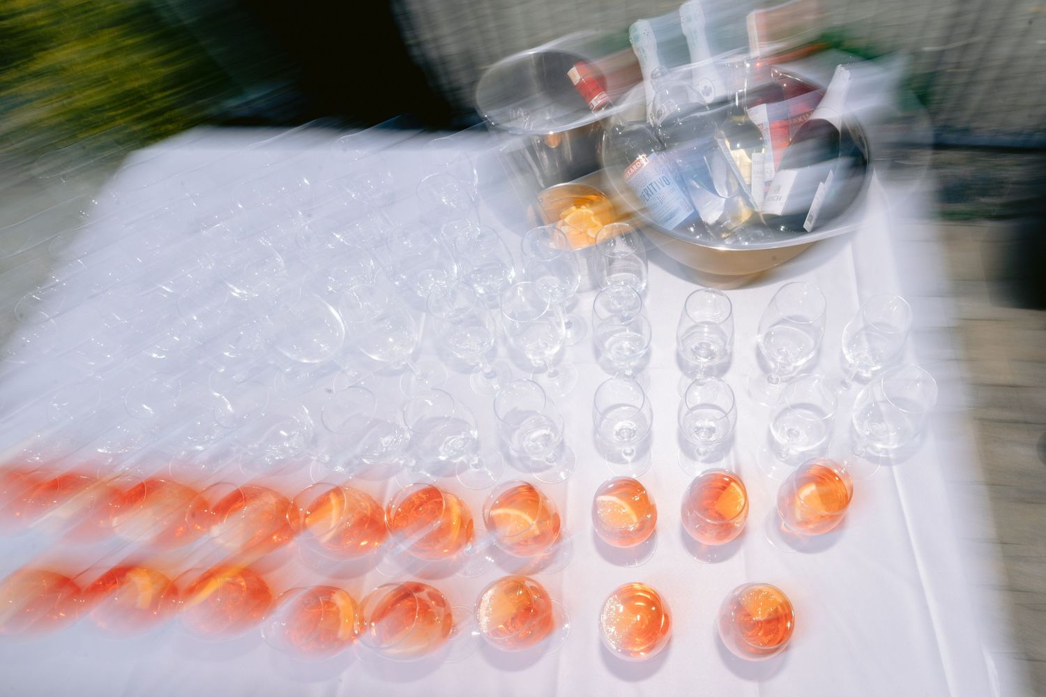 A sequence of sushi rolls being prepared and arranged in a line on a white surface showing progressive assembly steps.