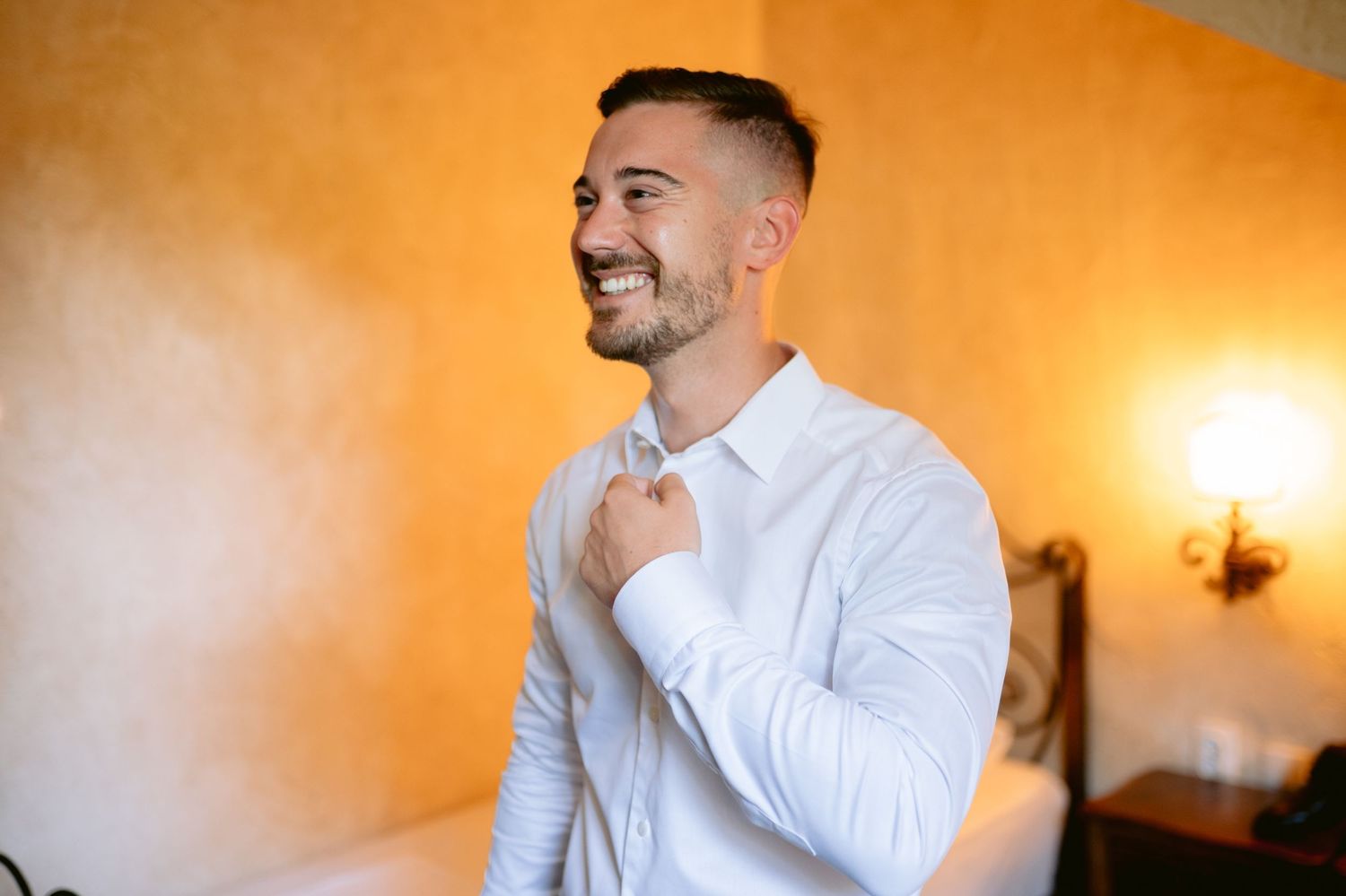 Wedding preparation photos with warm orange lighting showing formal attire details.