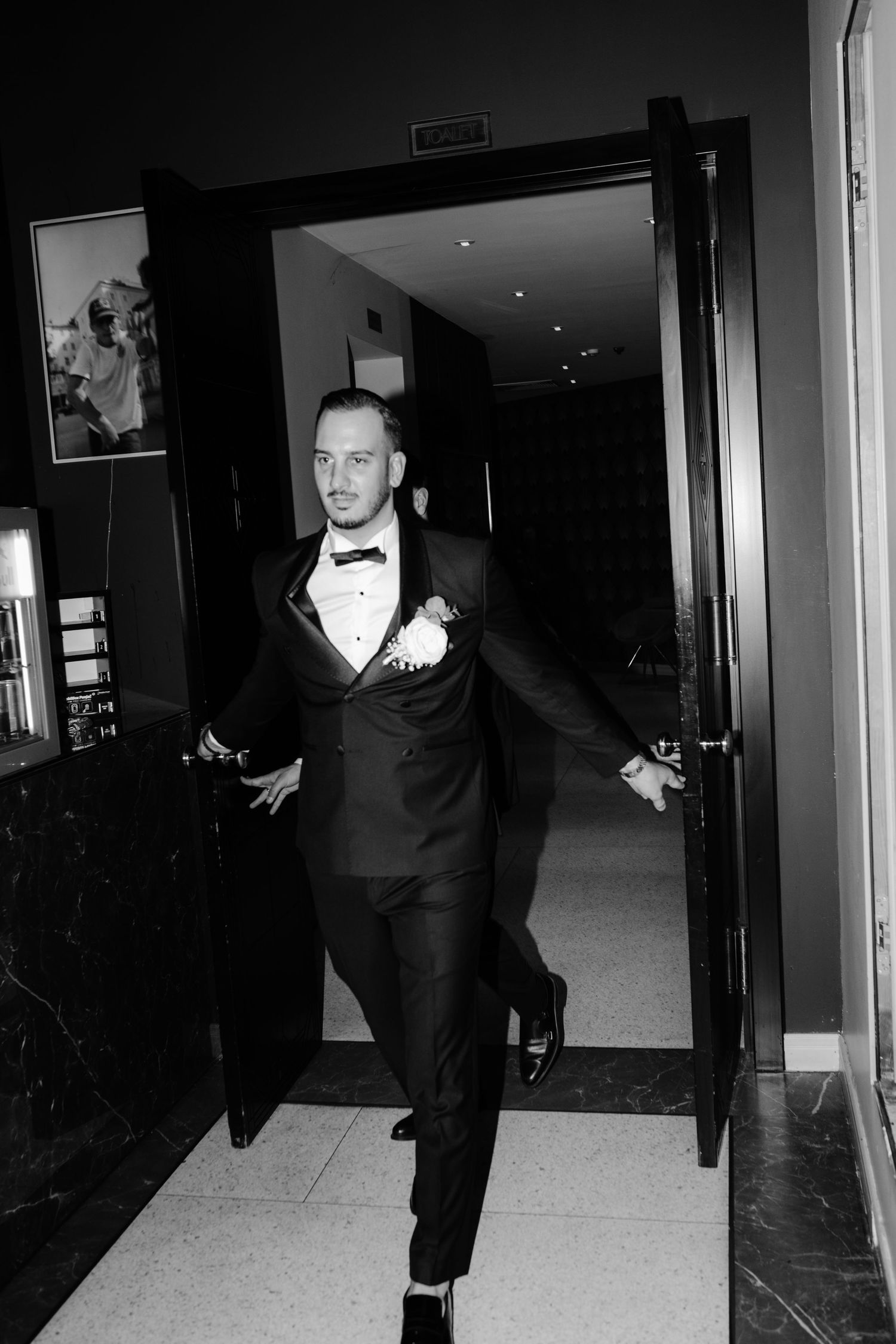 A black and white photo series showing figures in formal attire walking through a hallway corridor.